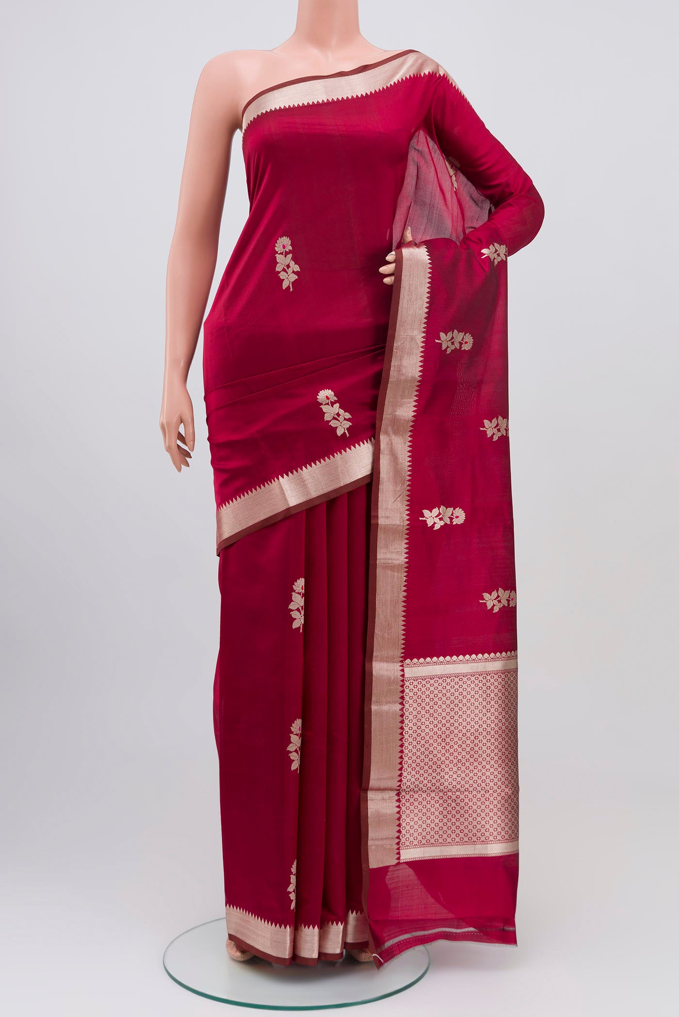 Maroon Banarasi Katan Silk Saree with Zari Butta on the body and Zari Border.  displayed on a mannequin