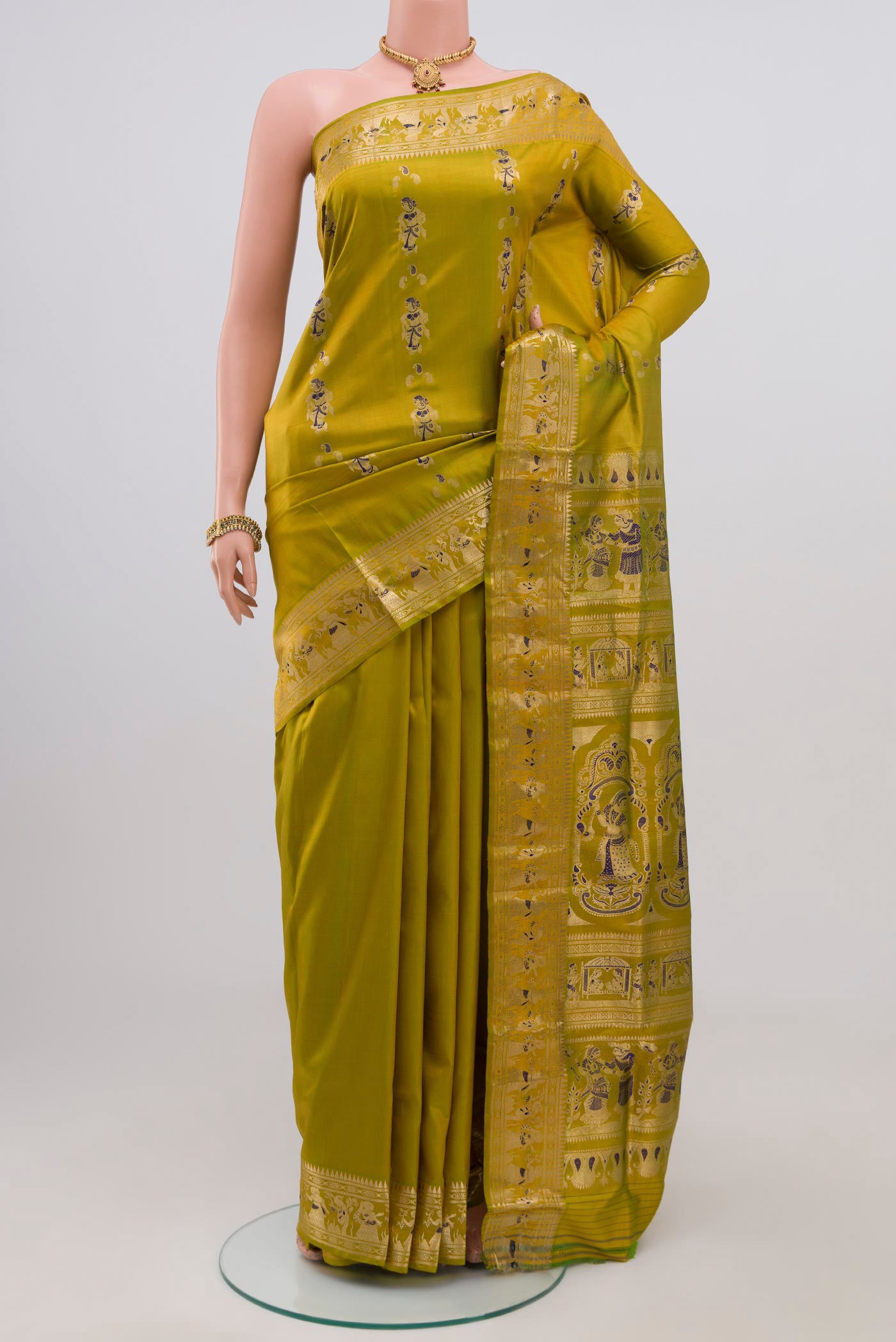 Green Baluchari Silk Saree with Zari Butta on the body and Zari Border.  displayed on a mannequin