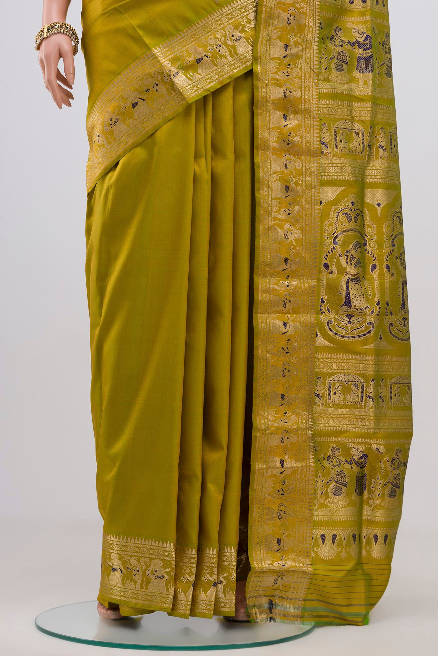 Pleats and pallu of Green Baluchari Silk Saree with Zari Butta on the body and Zari Border. 