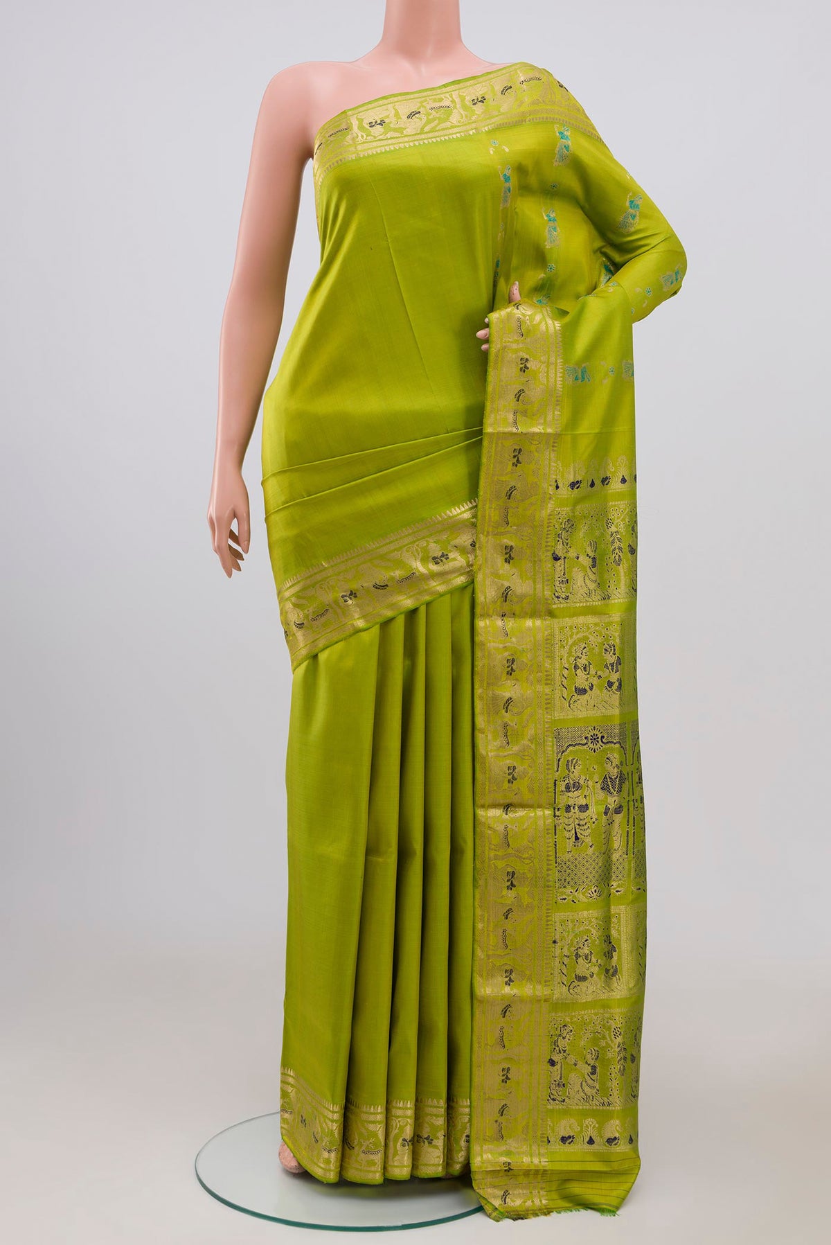 Green Baluchari Silk Saree with Zari Butta on the body and Zari Border.  displayed on a mannequin