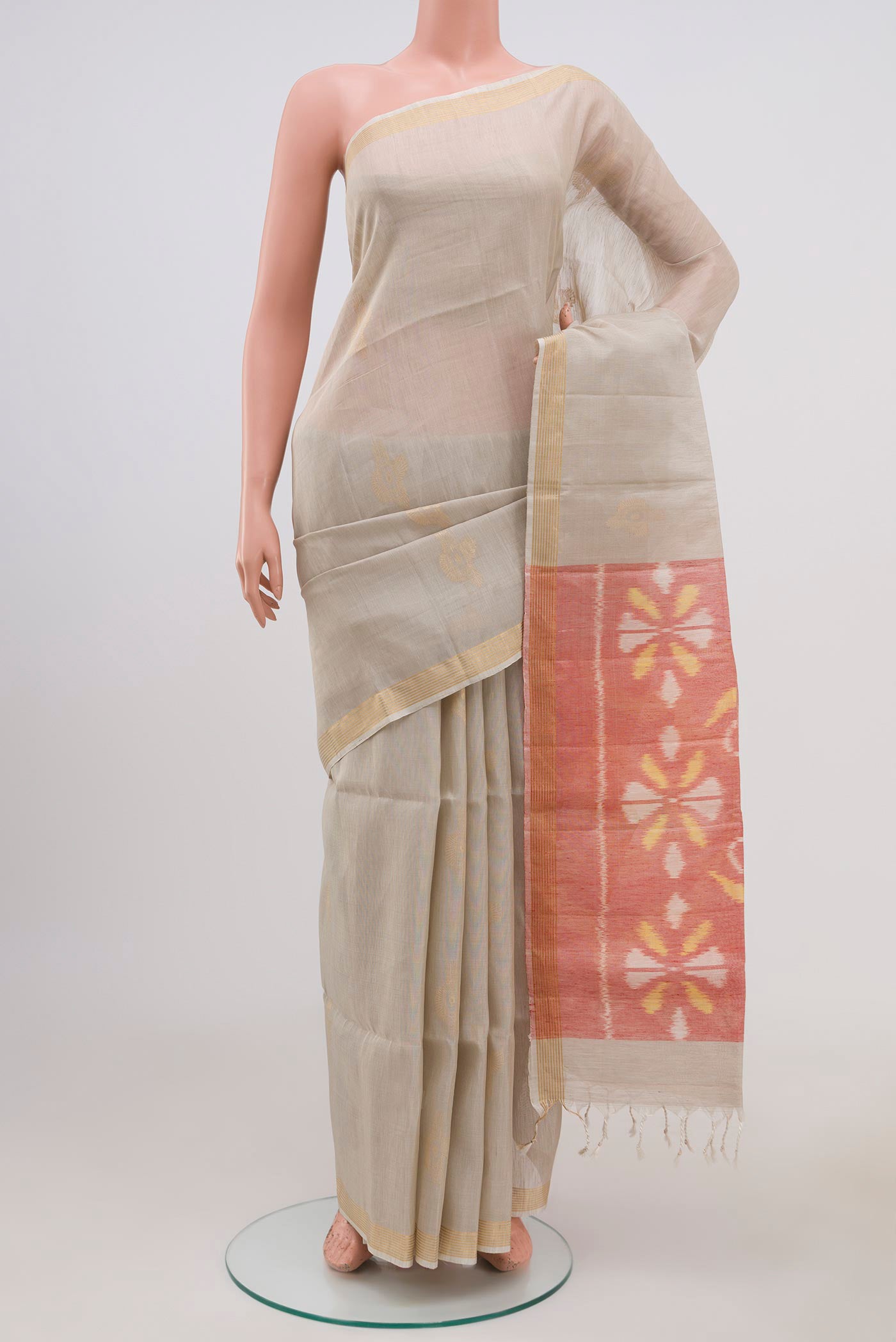 Cream Soft Silk Saree with Zari Butta on the body and Thin Zari Line.  displayed on a mannequin