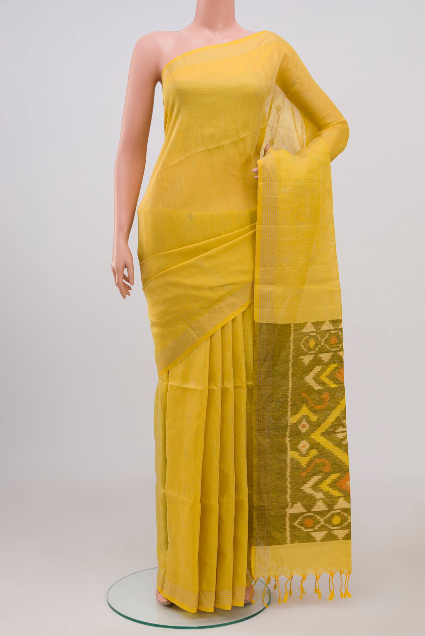 Yellow Soft Silk Saree with Zari Butta on the body and Thin Zari Line.  displayed on a mannequin