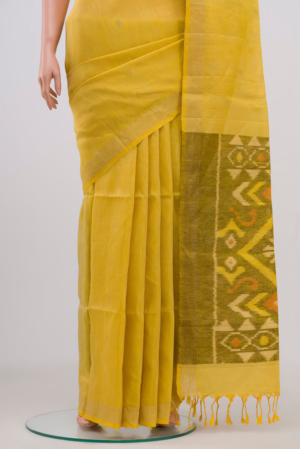 Pleats and pallu of Yellow Soft Silk Saree with Zari Butta on the body and Thin Zari Line. 