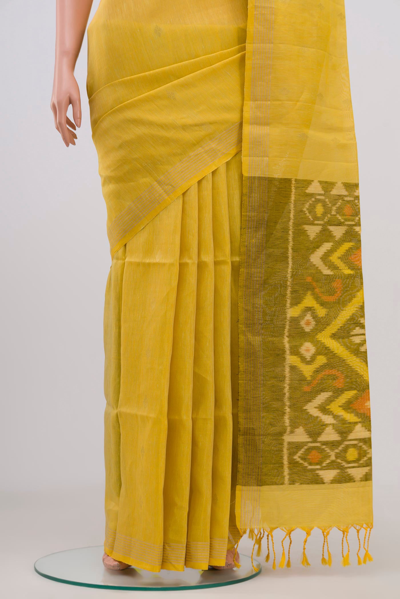 Pleats and pallu of Yellow Soft Silk Saree with Zari Butta on the body and Thin Zari Line. 