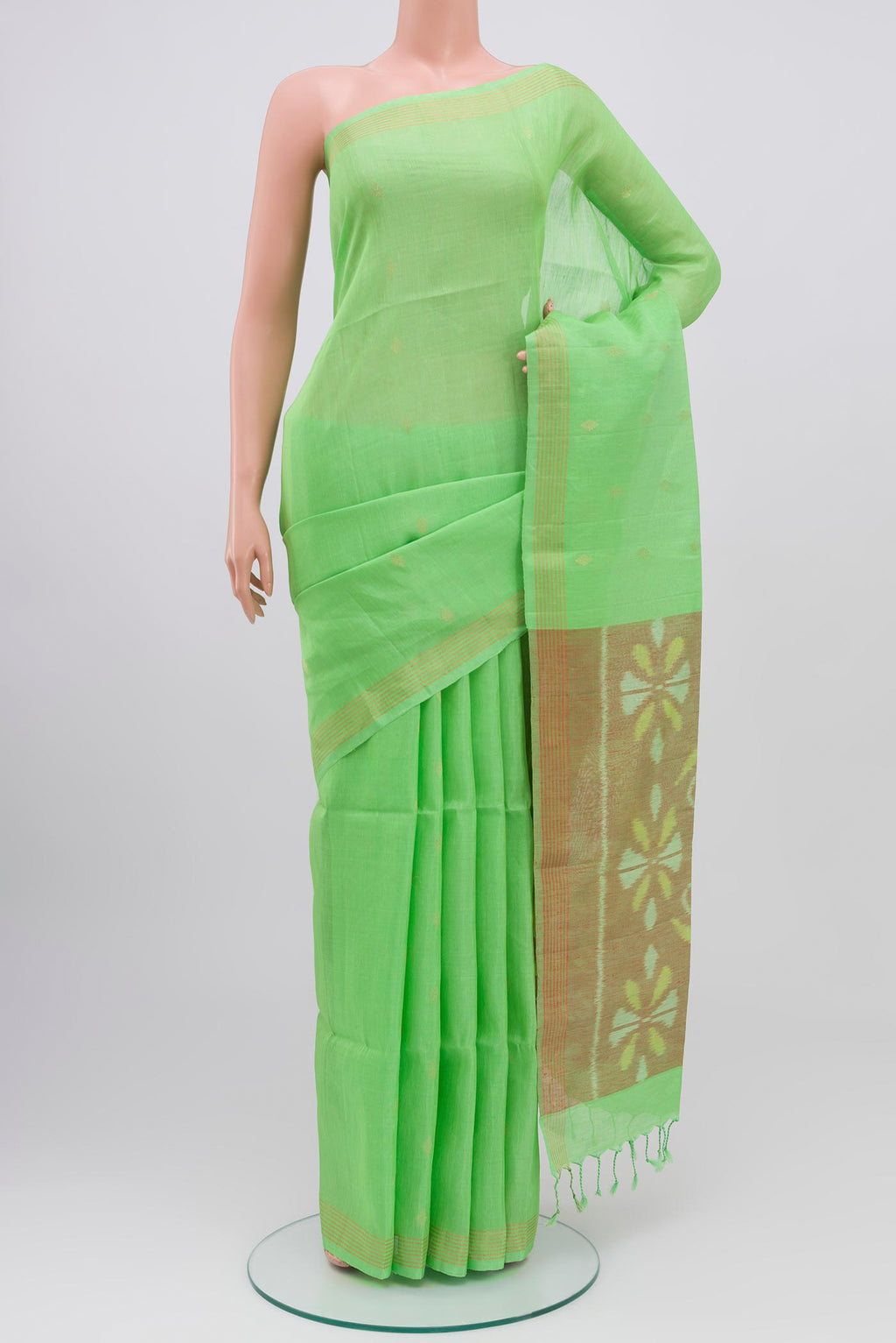 Green Soft Silk Saree with Zari Butta on the body and Zari Border.  displayed on a mannequin