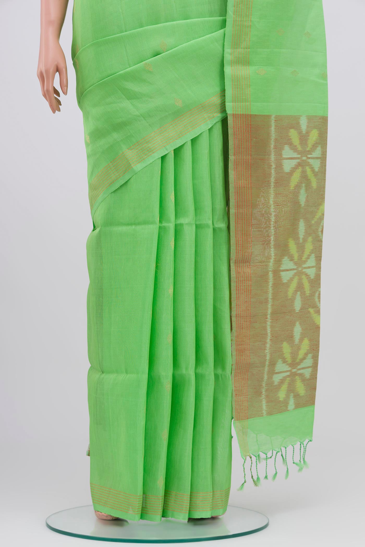 Pleats and pallu of Green Soft Silk Saree with Zari Butta on the body and Zari Border. 