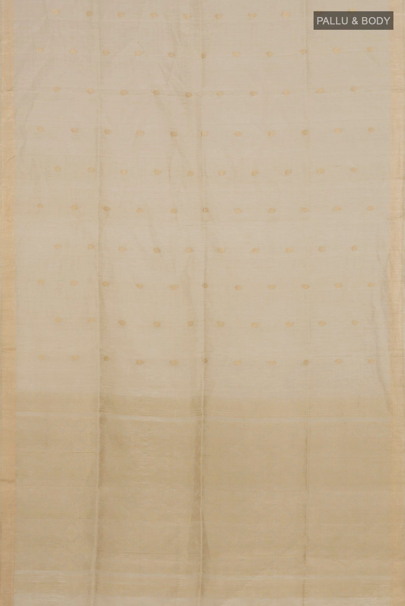 Flat view of Beige Soft Silk Saree with Zari Butta on the body and Thin Zari Line. 