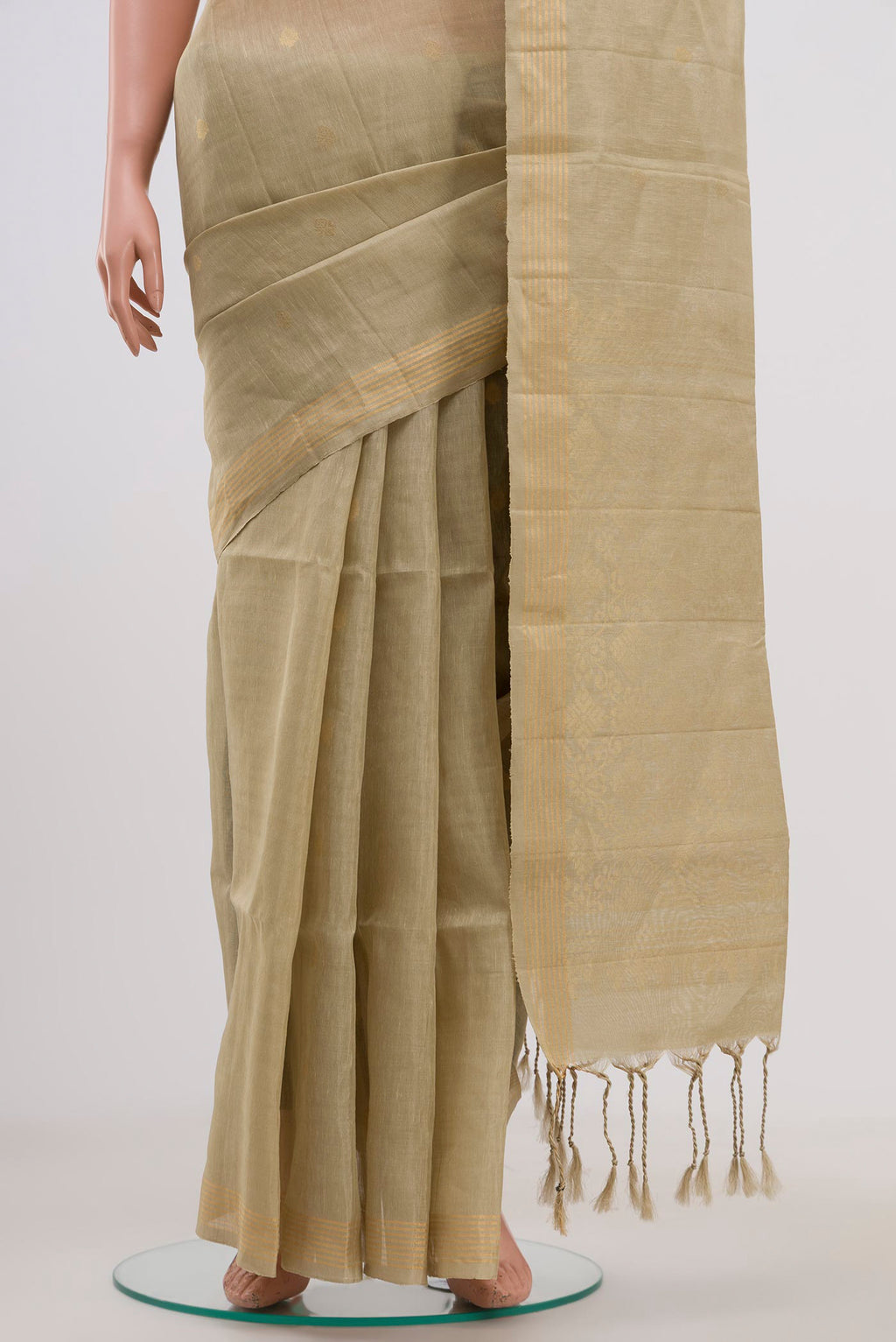 Pleats and pallu of Beige Soft Silk Saree with Zari Butta on the body and Thin Zari Line. 