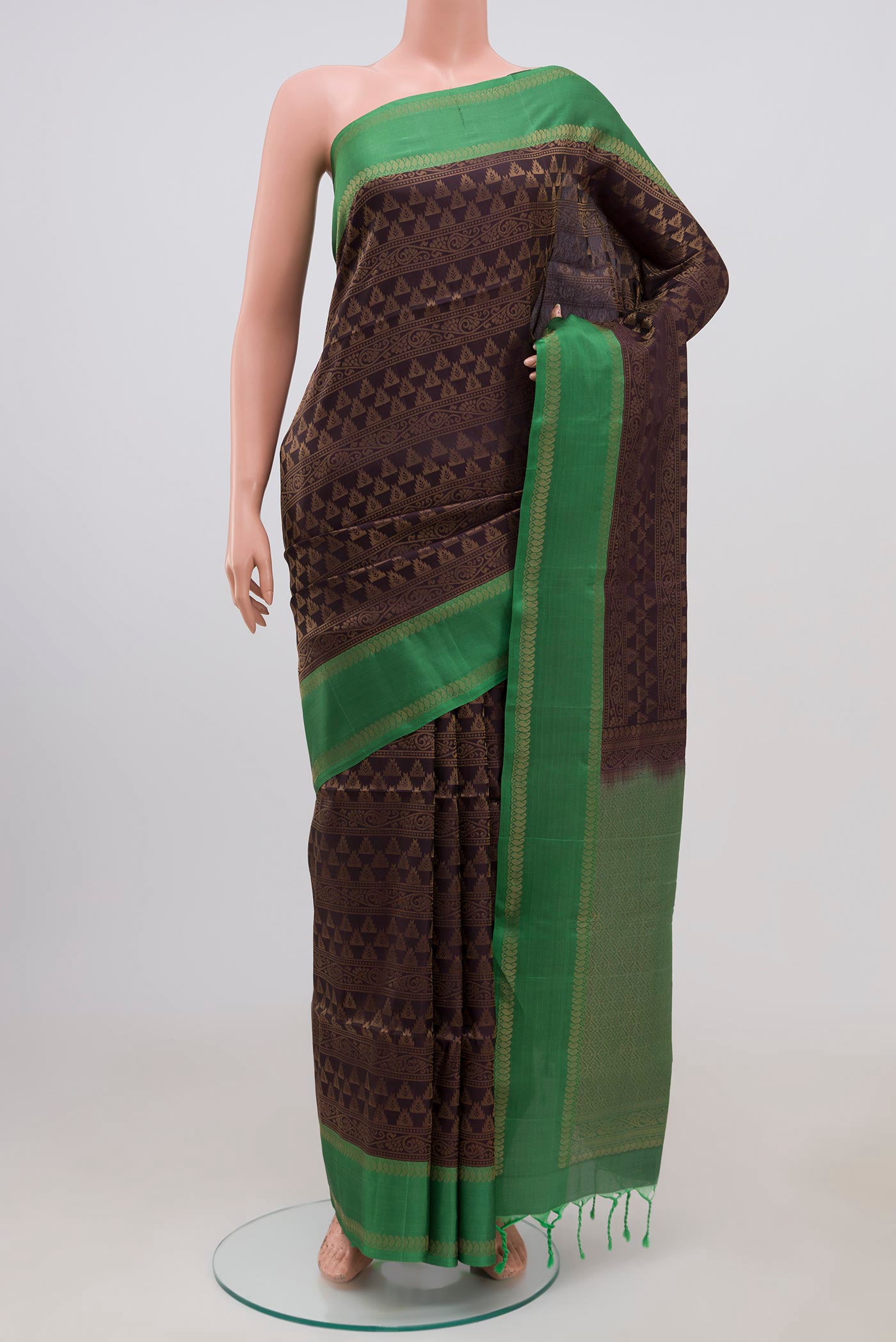 Brown Soft Silk Saree with Zari Brocade on the body and Thin Zari Line.  displayed on a mannequin