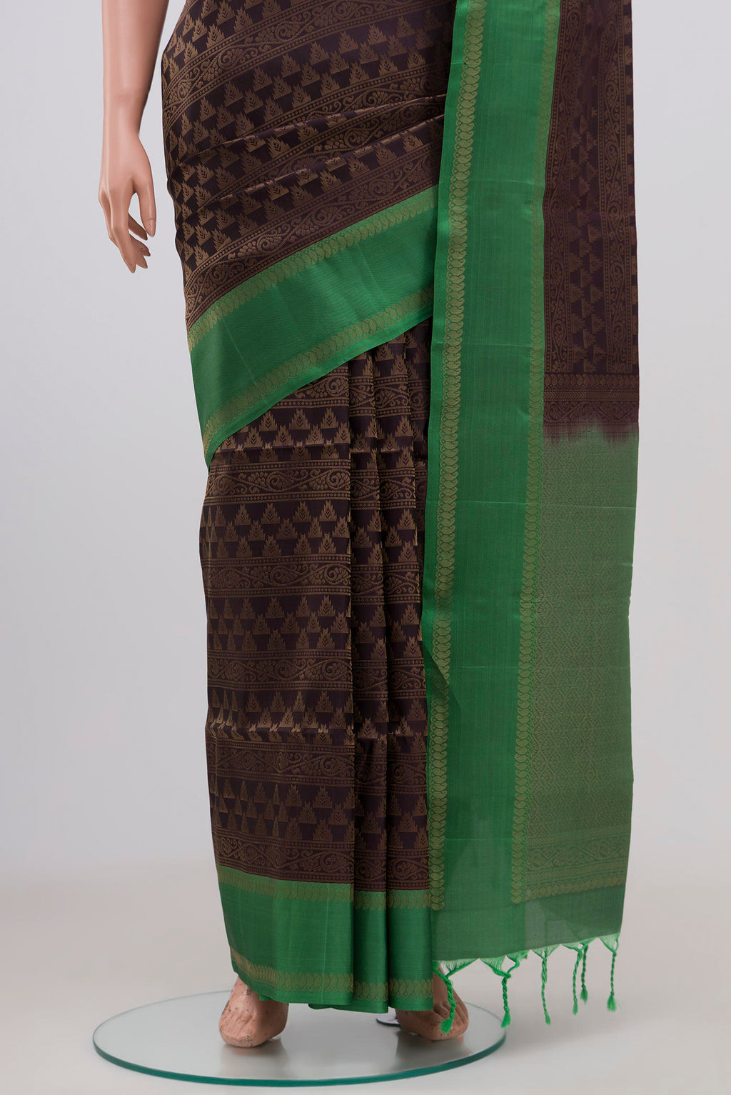 Pleats and pallu of Brown Soft Silk Saree with Zari Brocade on the body and Thin Zari Line. 