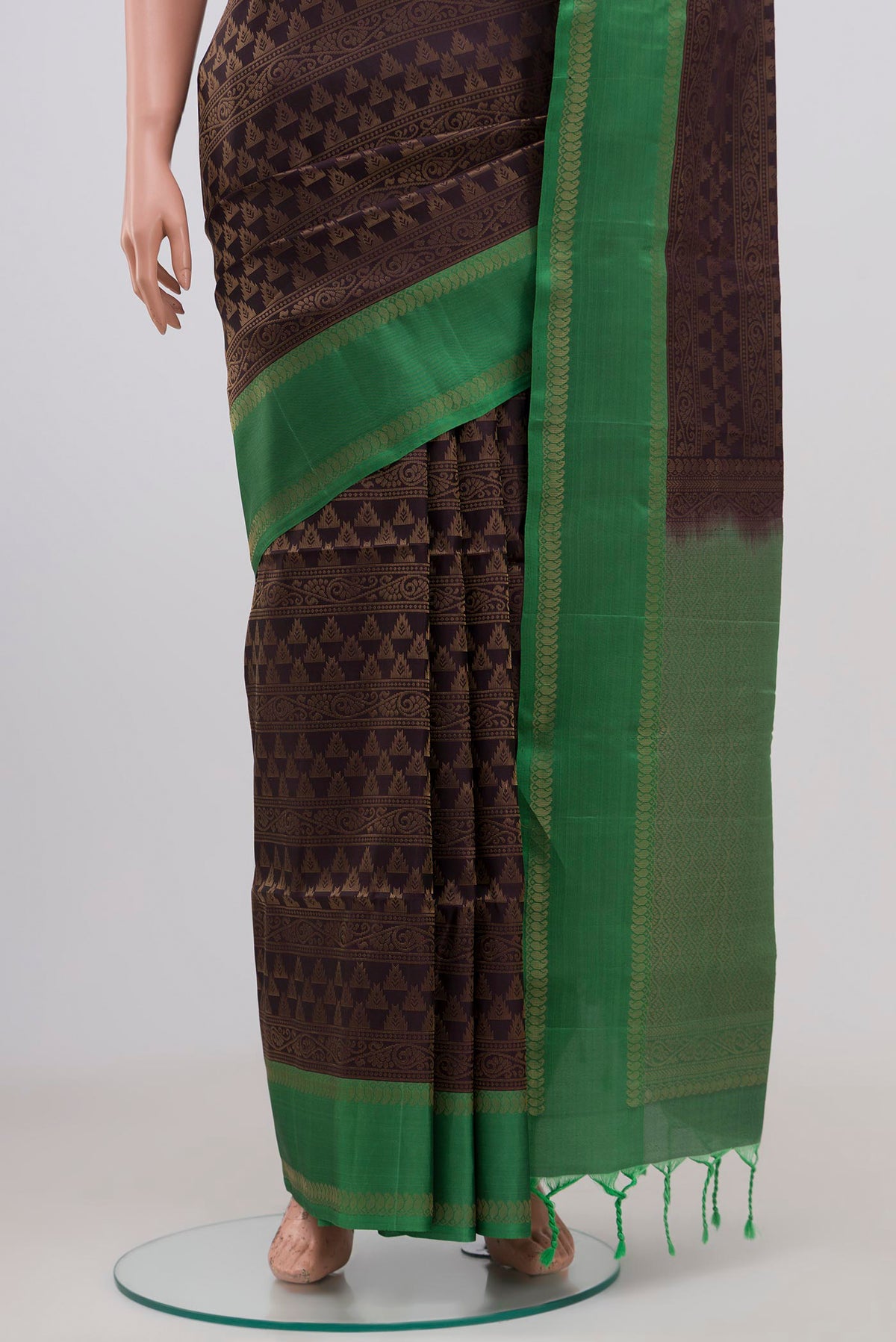 Pleats and pallu of Brown Soft Silk Saree with Zari Brocade on the body and Thin Zari Line. 