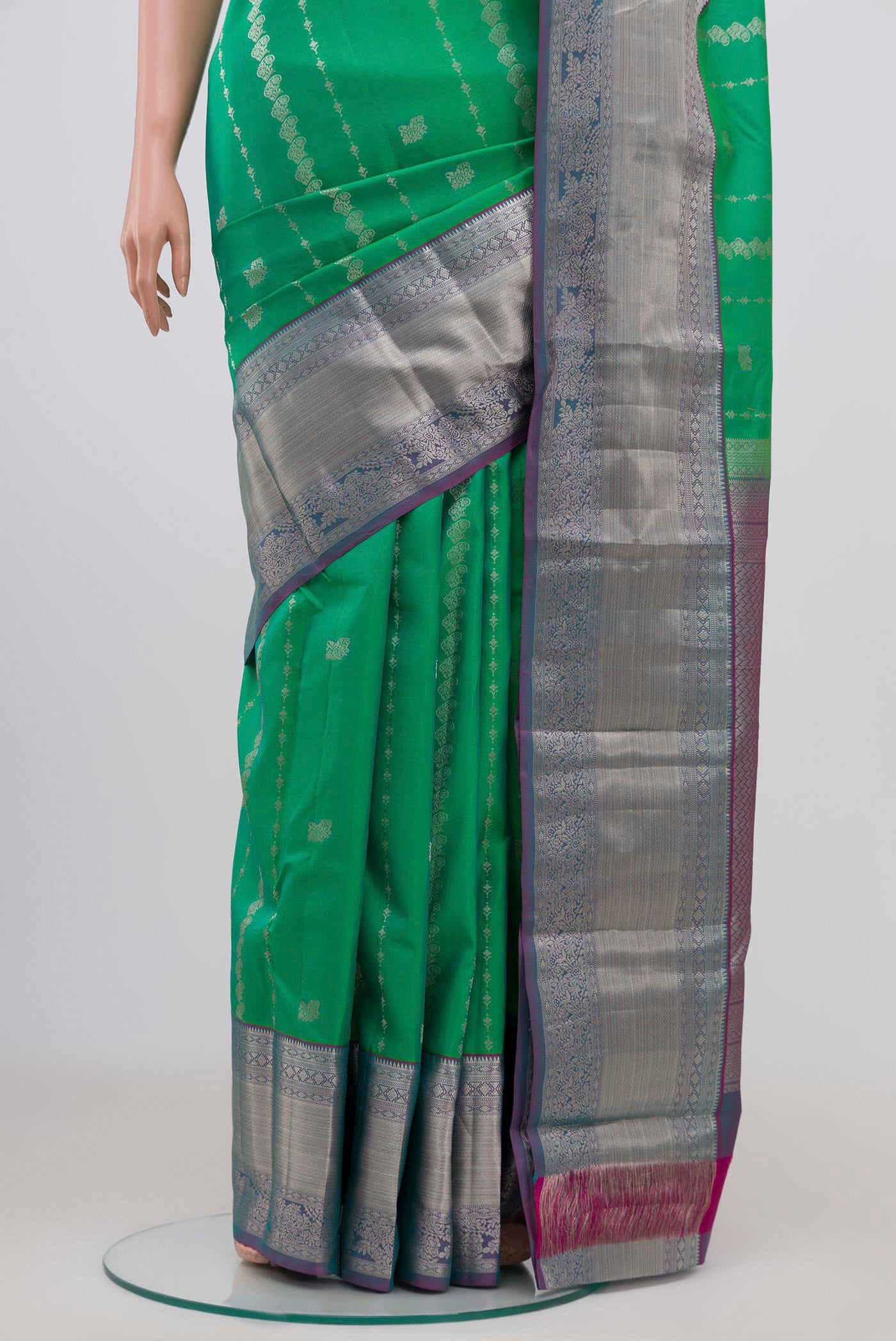 Pleats and pallu of Green Kanchipuram Silk Saree with Zari Butta on the body and Zari Border. 