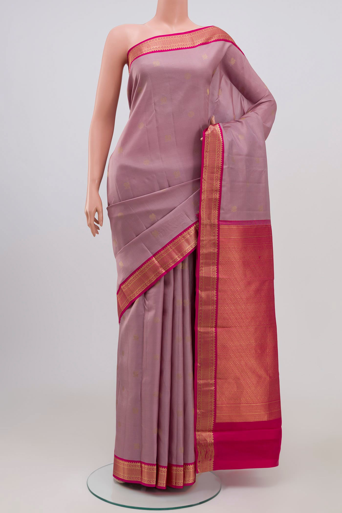 Lavender Kanchipuram Silk Saree with Zari Butta on the body and Zari Border.  displayed on a mannequin
