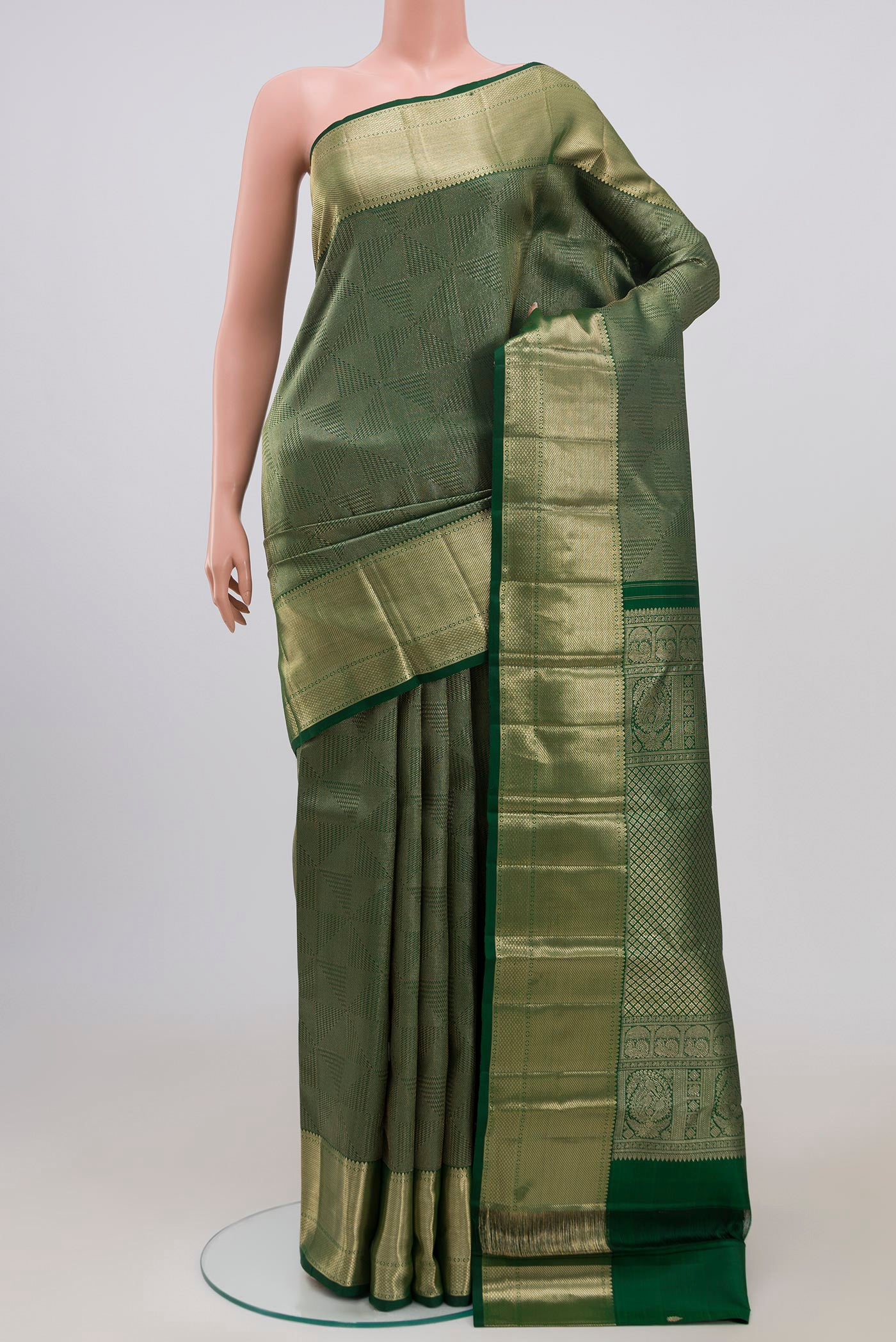 Green Kanchipuram Saree with Zari Brocade on the body and Zari Border.  displayed on a mannequin