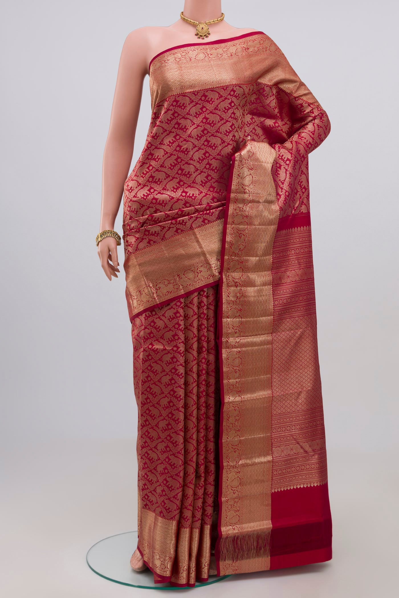 Maroon Kanchipuram Silk Saree with Zari Brocade on the body and Zari Border.  displayed on a mannequin