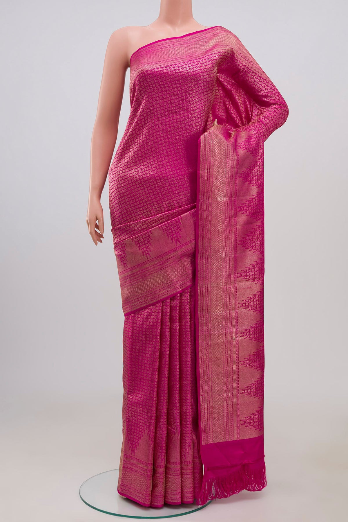 Pink Kanchipuram Silk Saree with Thread Brocade on the body and Zari Border.  displayed on a mannequin