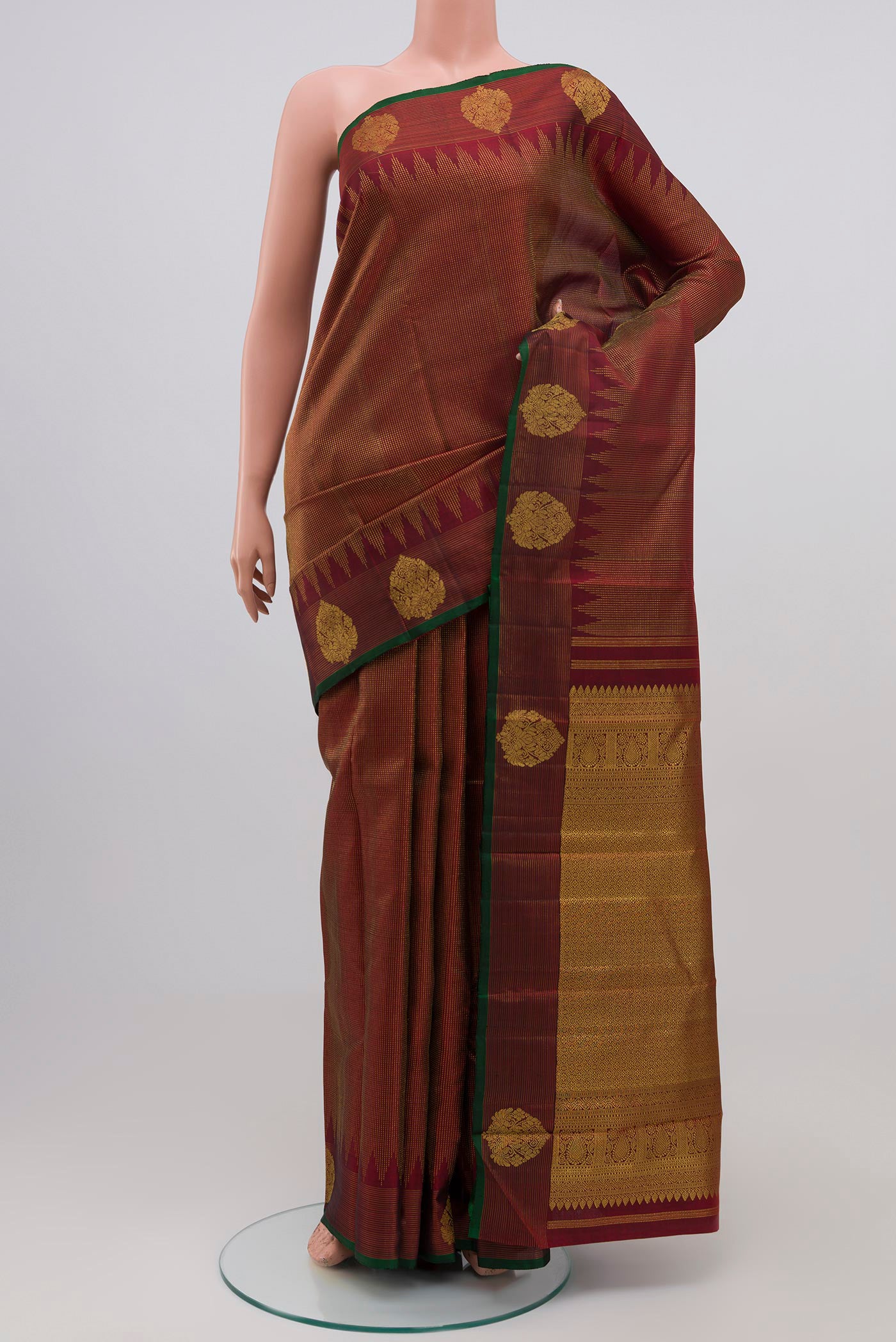 Maroon Kanjivaram Silk Saree with Zari Brocade on the body and Zari Border.  displayed on a mannequin