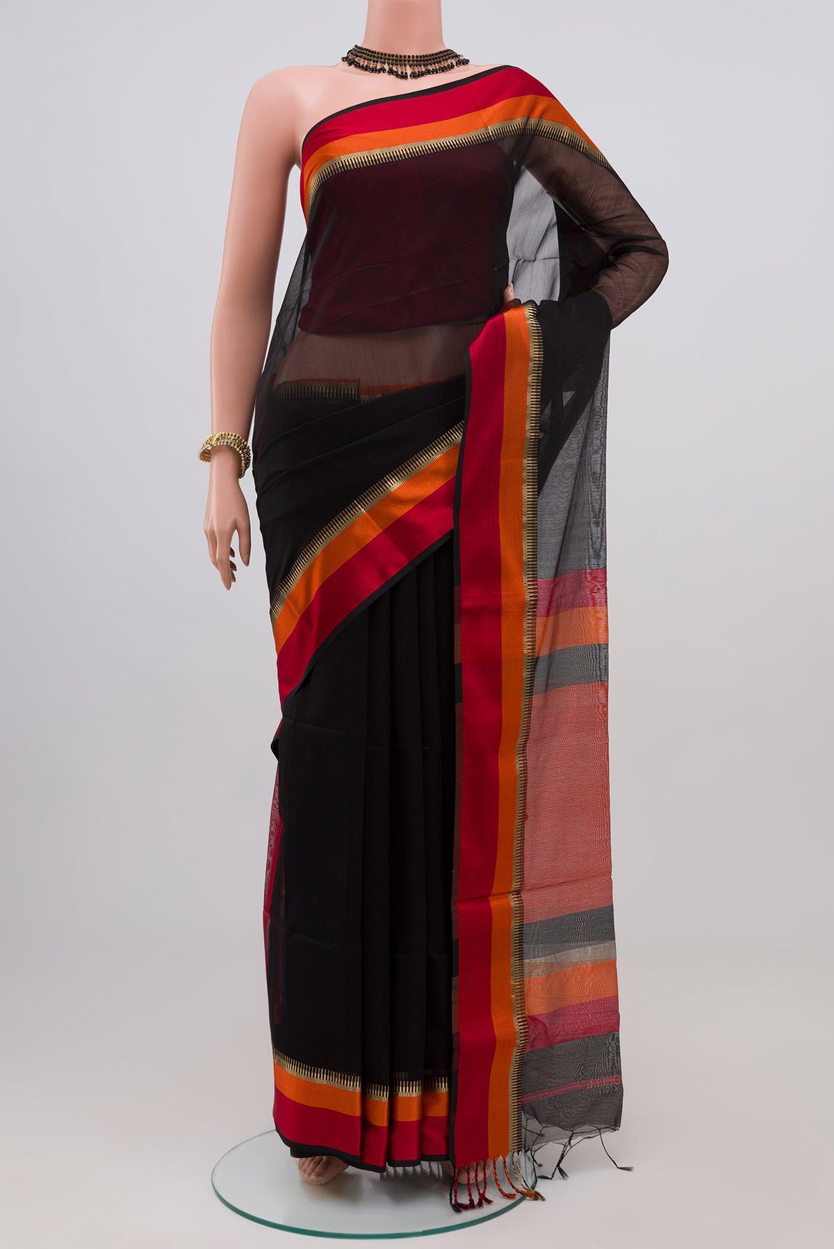 Black Maheshwari Silk Saree with Plain Body and Zari Border.  displayed on a mannequin
