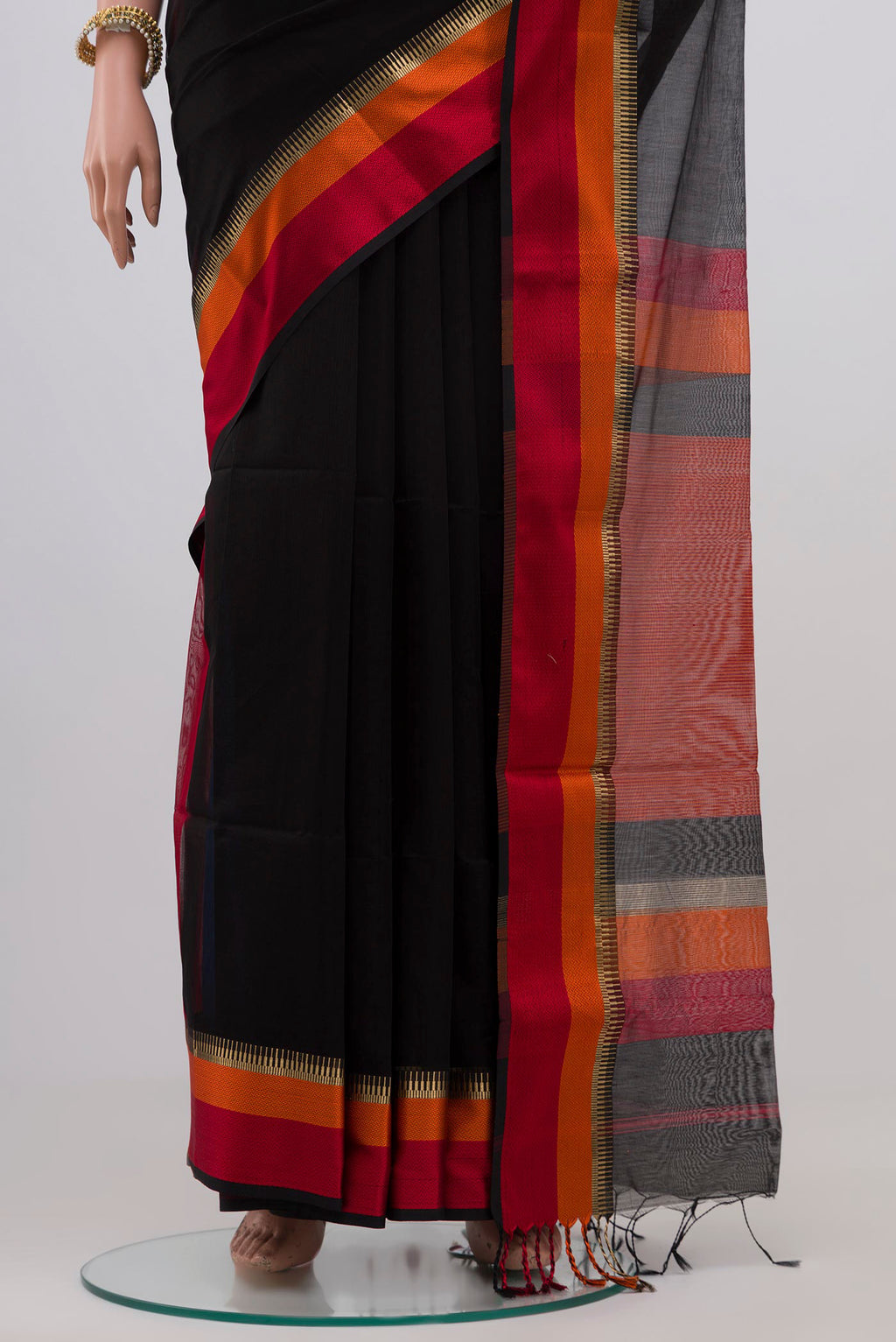 Pleats and pallu of Black Maheshwari Silk Saree with Plain Body and Zari Border. 