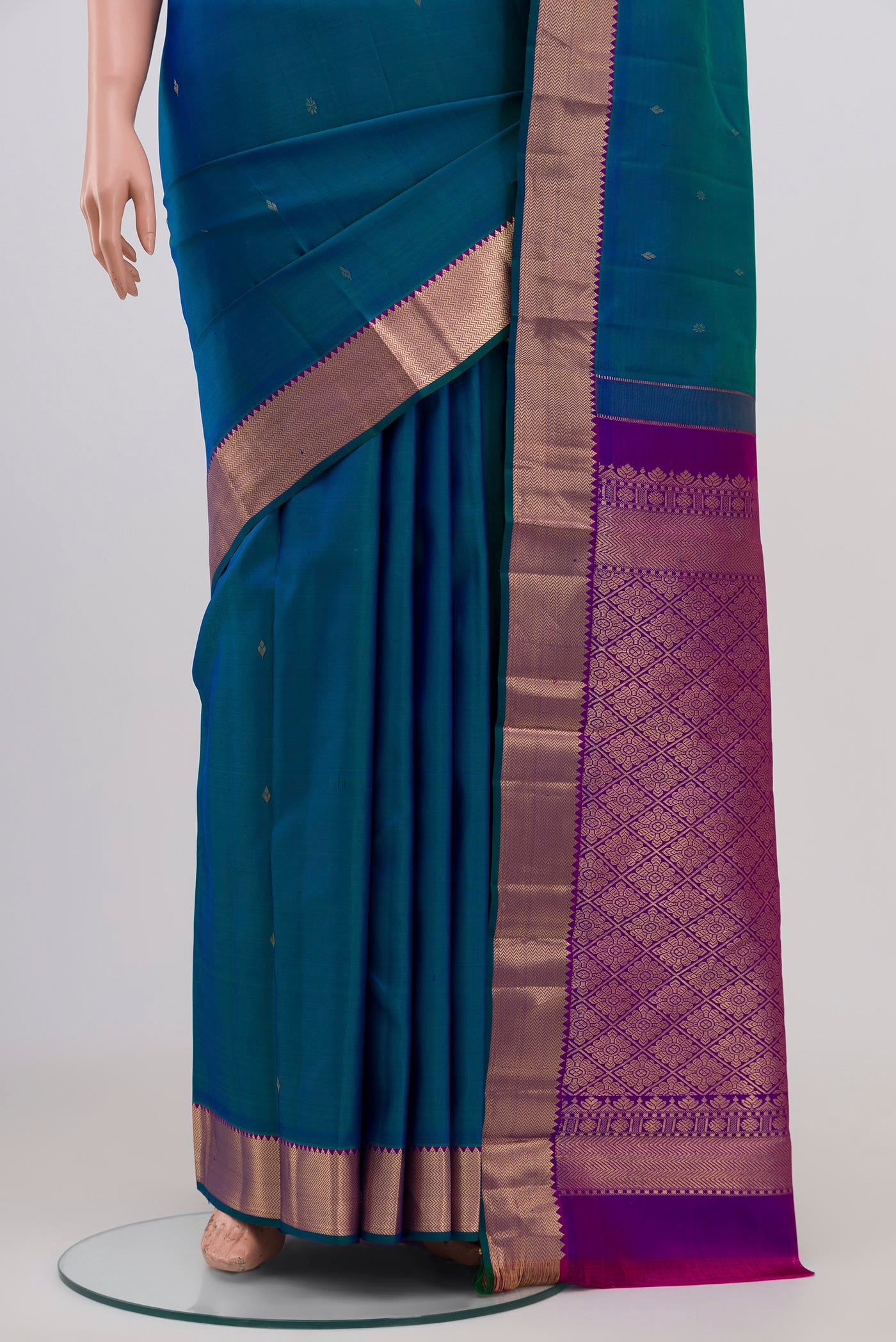 Pleats and pallu of Peacock Blue Kanjivaram Silk Saree with Zari Butta on the body and Zari Border. 