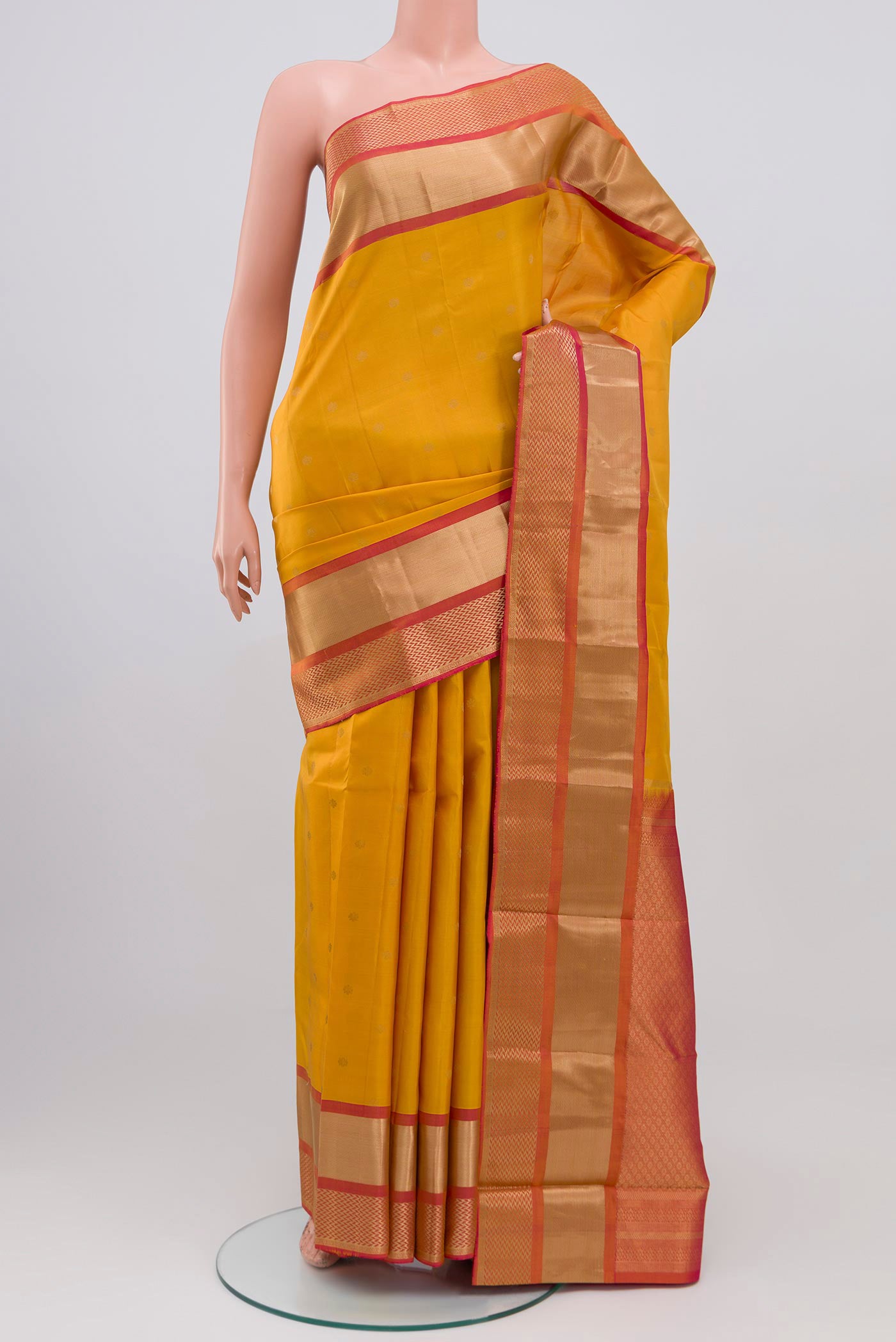 Yellow Kanchipuram Saree with Zari Butta on the body and Zari Border.  displayed on a mannequin