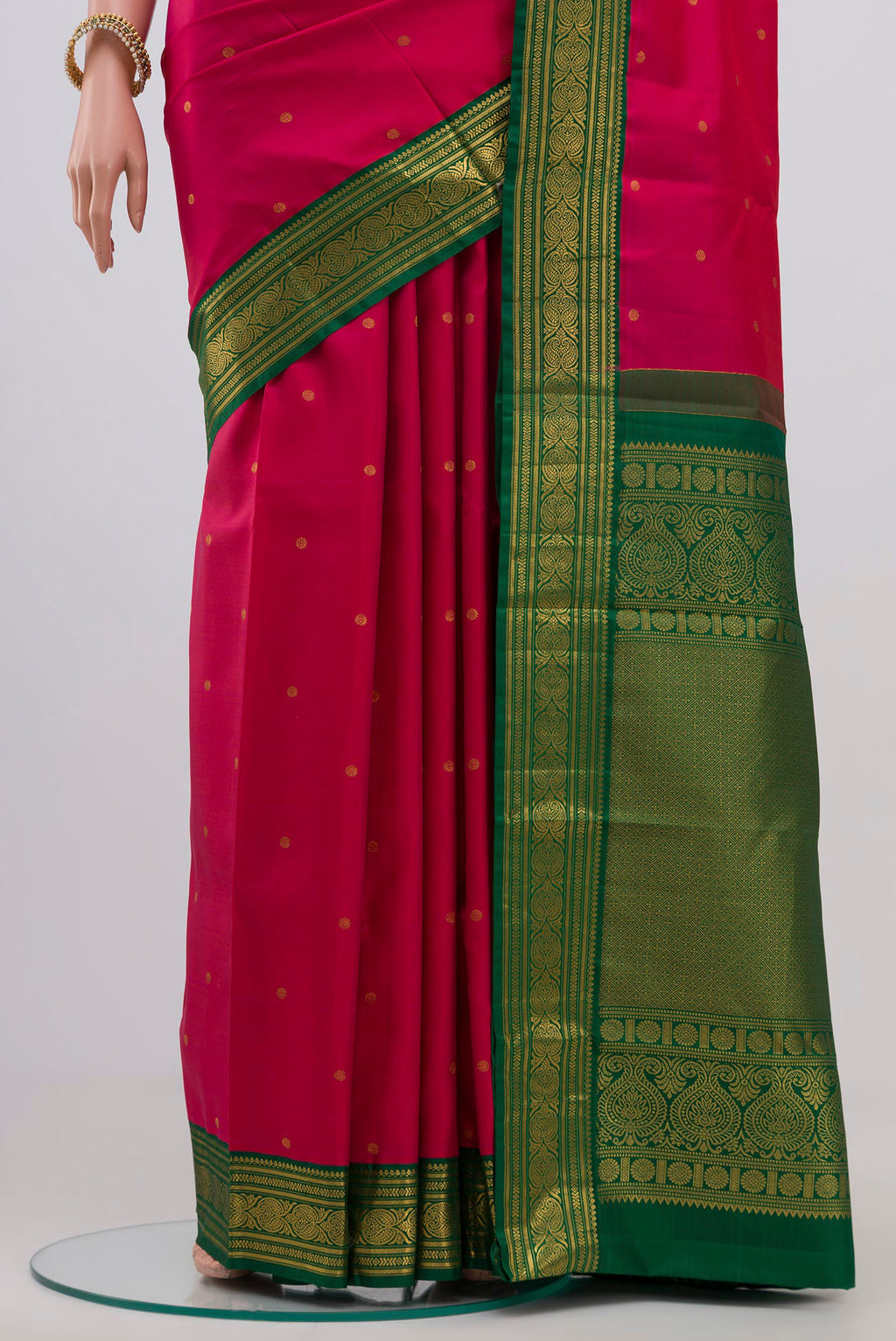 Pleats and pallu of Rani Pink Kanjivaram Silk Saree with Zari Butta on the body and Zari Border. 