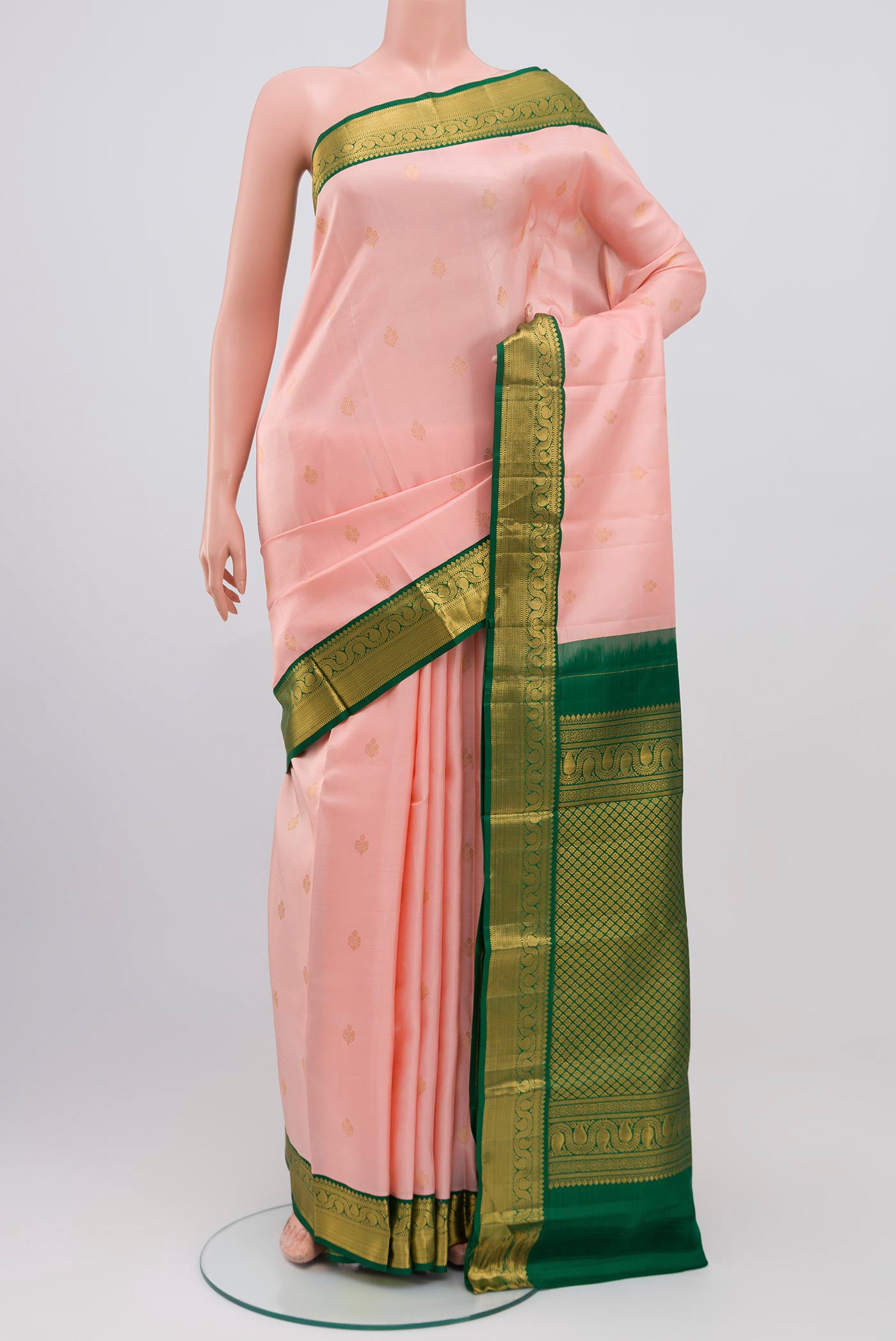 Pink Kanjivaram Saree with Zari Butta on the body and Zari Border.  displayed on a mannequin
