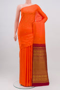 Orange Kanchipuram Saree with Zari Butta on the body and Without Border.  displayed on a mannequin