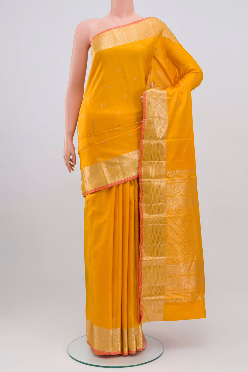 Yellow Kanjivaram Saree with Zari Butta on the body and Zari Border.  displayed on a mannequin