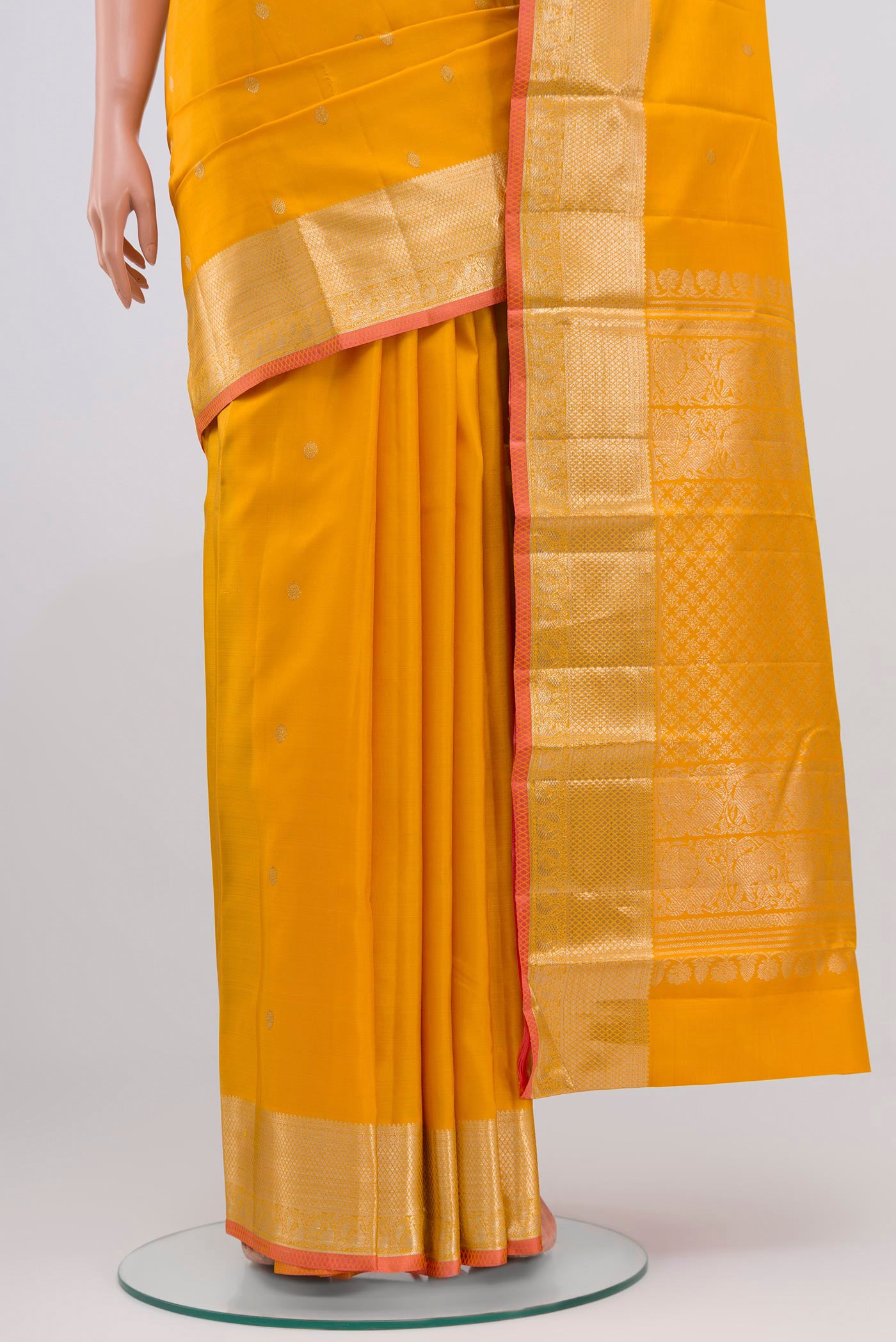 Pleats and pallu of Yellow Kanjivaram Saree with Zari Butta on the body and Zari Border. 