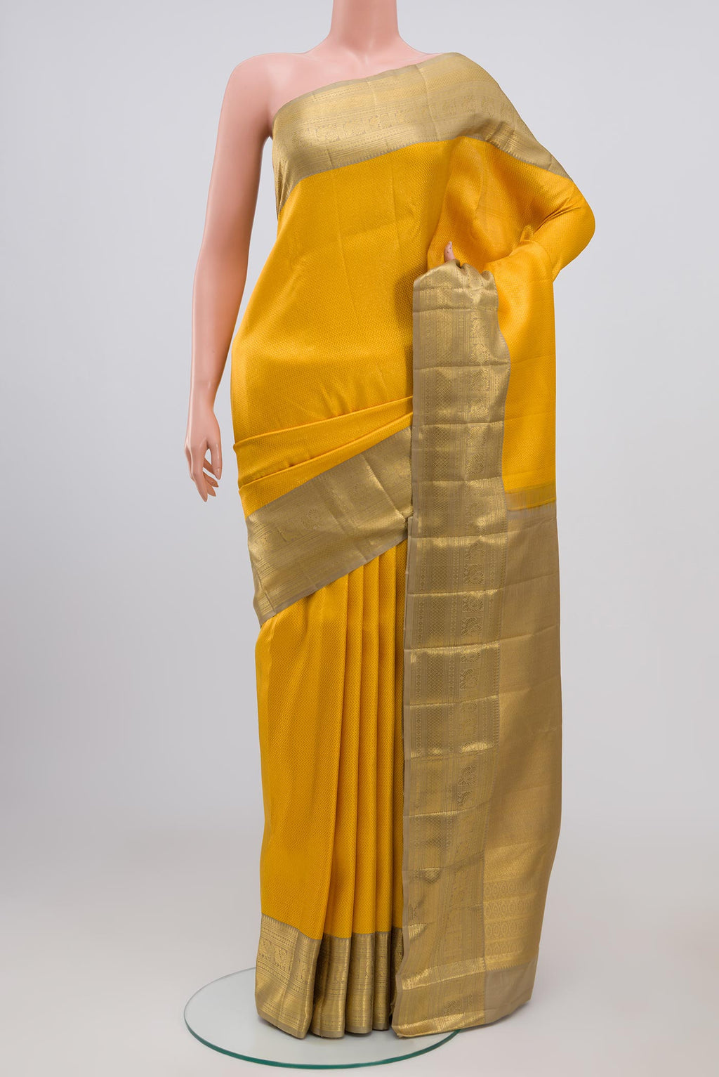 Yellow Kanchipuram Saree with Zari Brocade on the body and Zari Border.  displayed on a mannequin