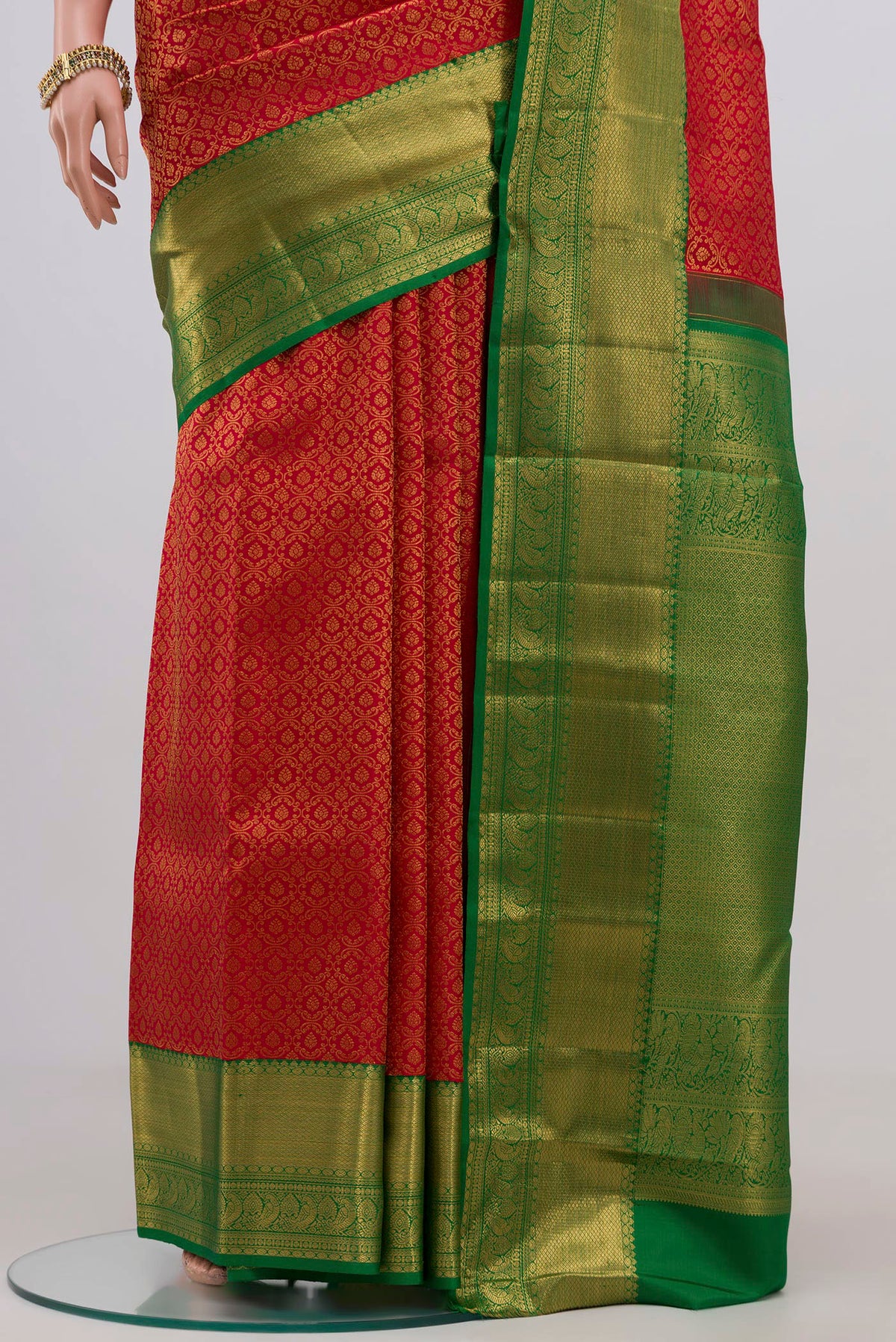 Pleats and pallu of Red Kanchipuram Silk Saree with Zari Brocade on the body and Zari Border. 