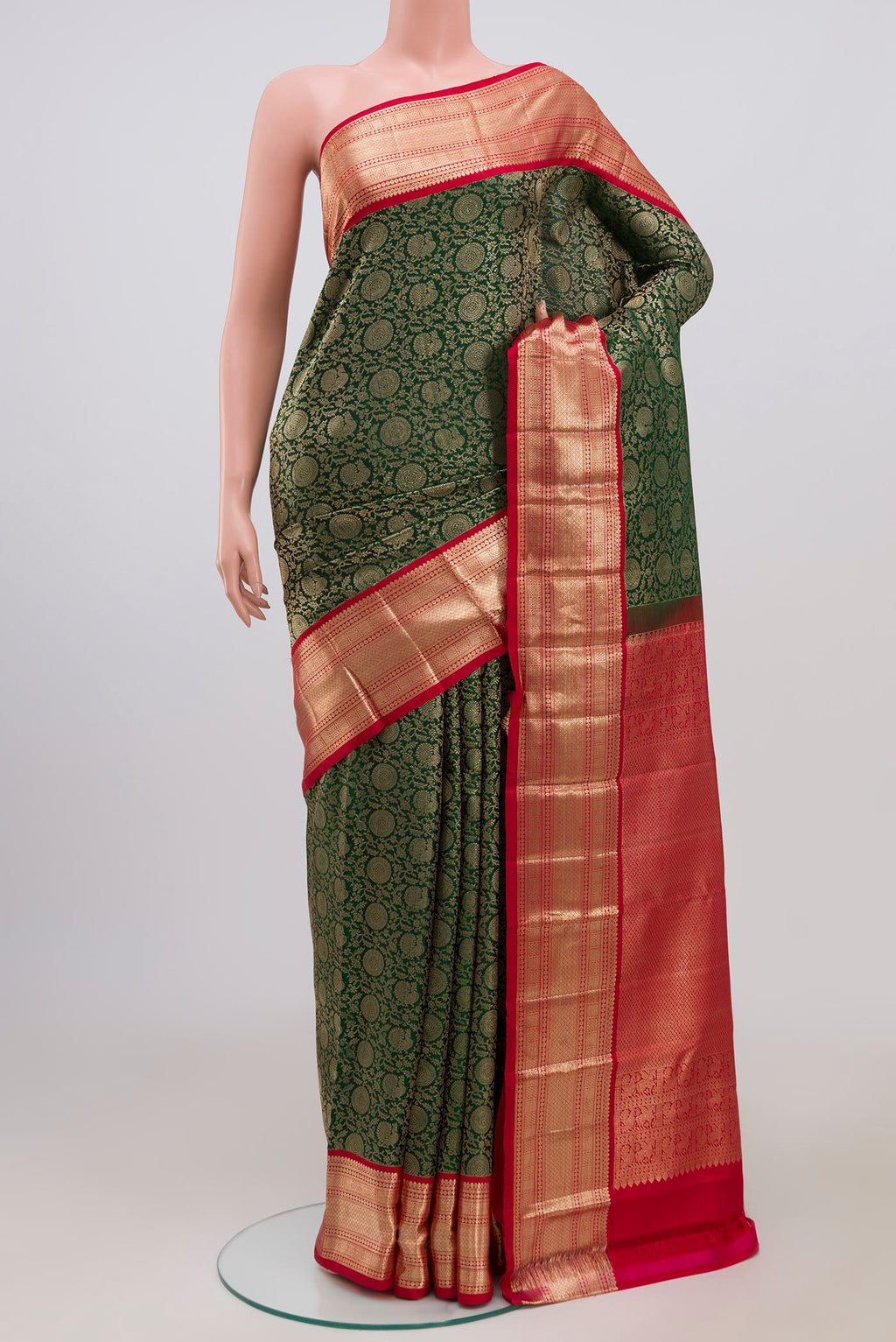Bottle Green Kanchipuram Saree with Zari Brocade on the body and Zari Border.  displayed on a mannequin