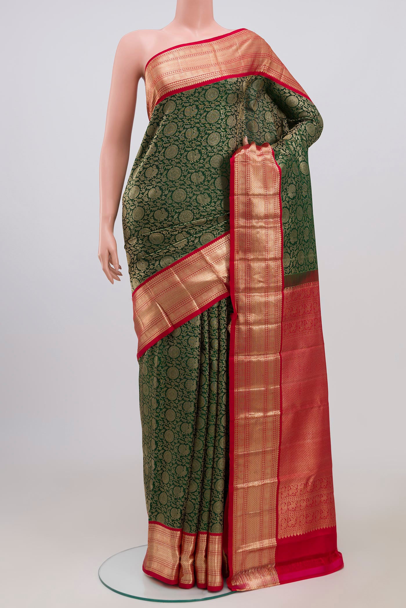Bottle Green Kanchipuram Saree with Zari Brocade on the body and Zari Border.  displayed on a mannequin