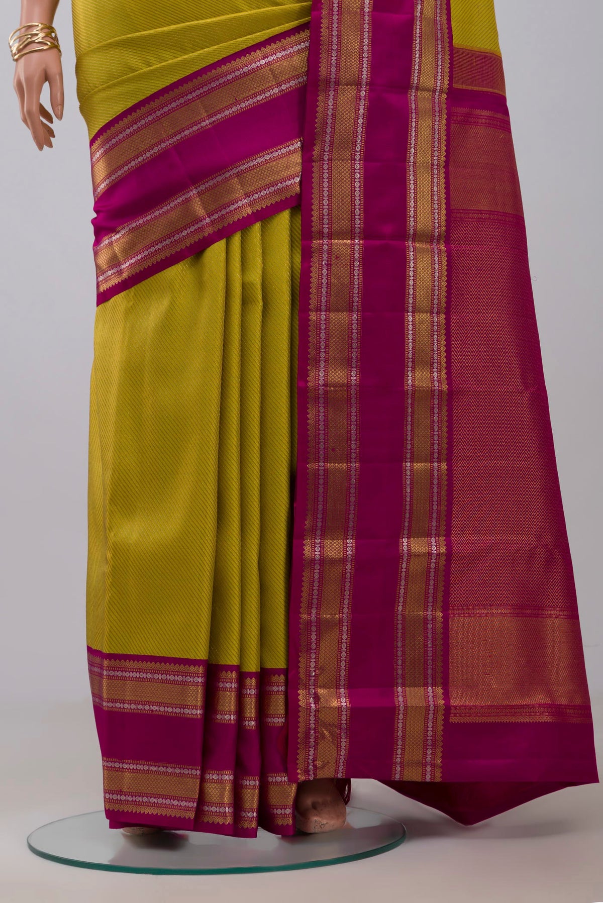 Pleats and pallu of Parrot Green Kanchipuram Saree with Zari Brocade on the body and Zari Border. 