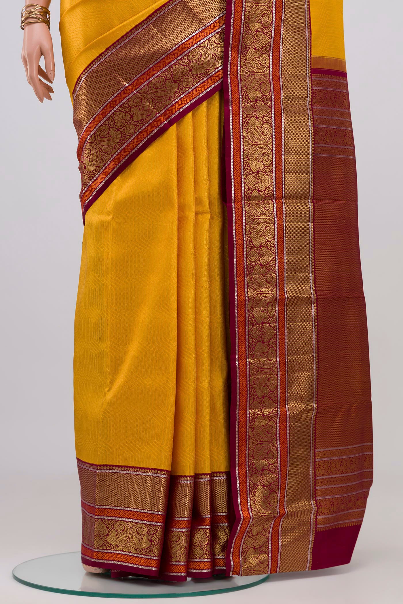 Pleats and pallu of Yellow Kanchipuram Silk Saree with Zari Brocade on the body and Zari Border. 