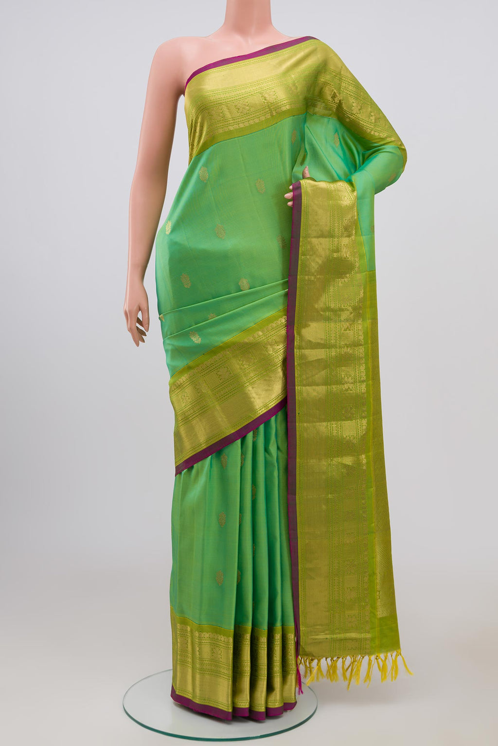 Green Gadwal Silk Saree with Zari Butta on the body and Zari Border.  displayed on a mannequin