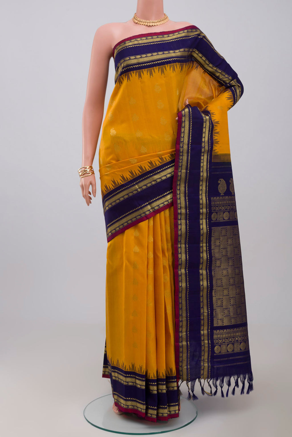 Yellow Gadwal Silk Saree with Zari Butta on the body and Zari Border.  displayed on a mannequin