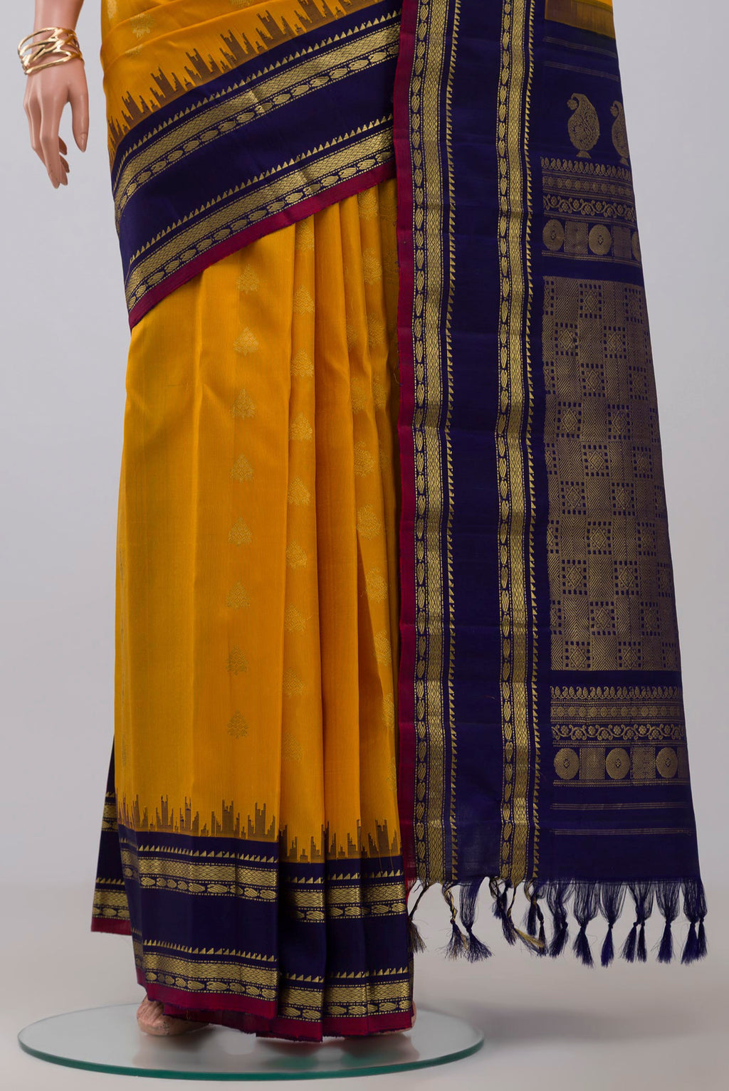 Pleats and pallu of Yellow Gadwal Silk Saree with Zari Butta on the body and Zari Border. 