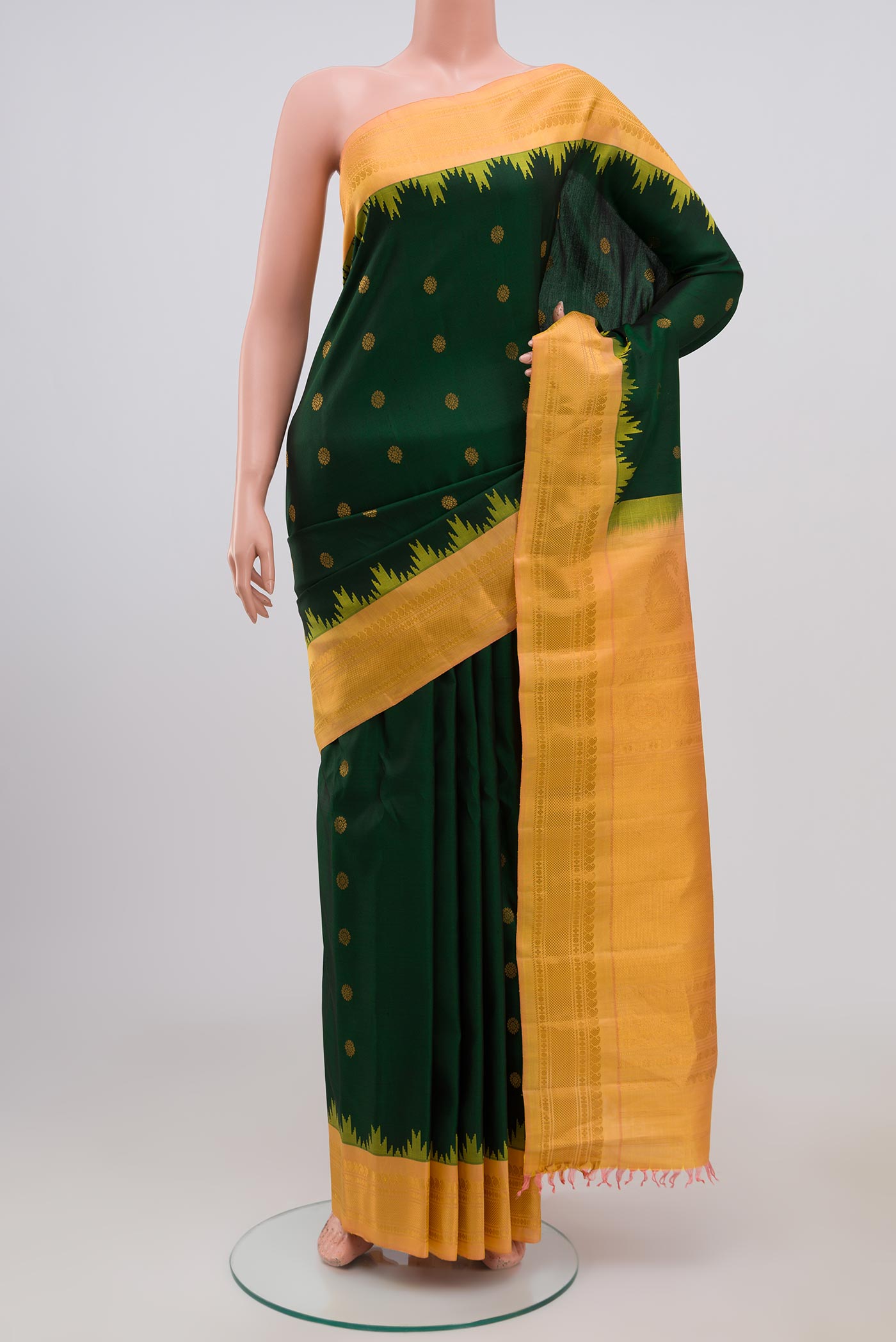 Green Gadwal Silk Saree with Zari Butta on the body and Zari Border.  displayed on a mannequin