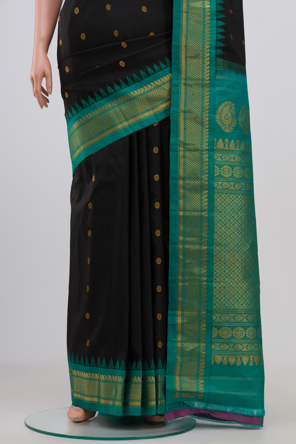 Pleats and pallu of Black Gadwal Silk Saree with Zari Butta on the body and Zari Border. 
