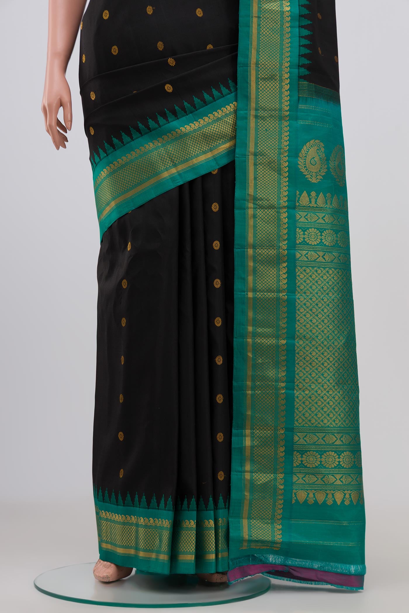 Pleats and pallu of Black Gadwal Silk Saree with Zari Butta on the body and Zari Border. 