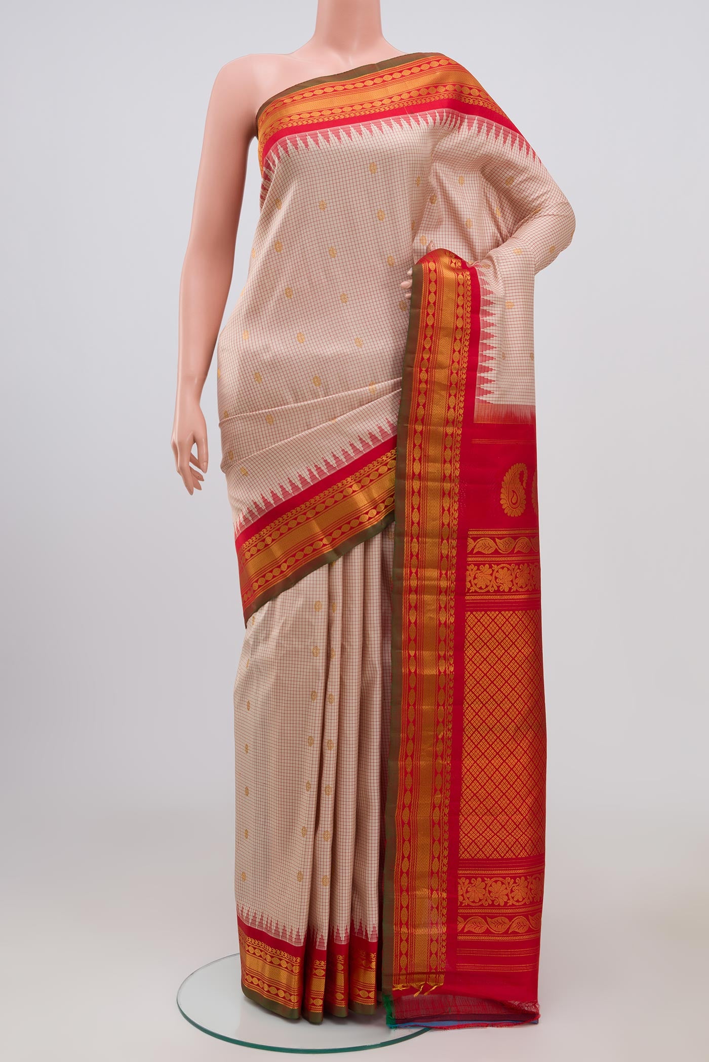 Cream Gadwal Silk Saree with Zari Butta on the body and Zari Border.  displayed on a mannequin