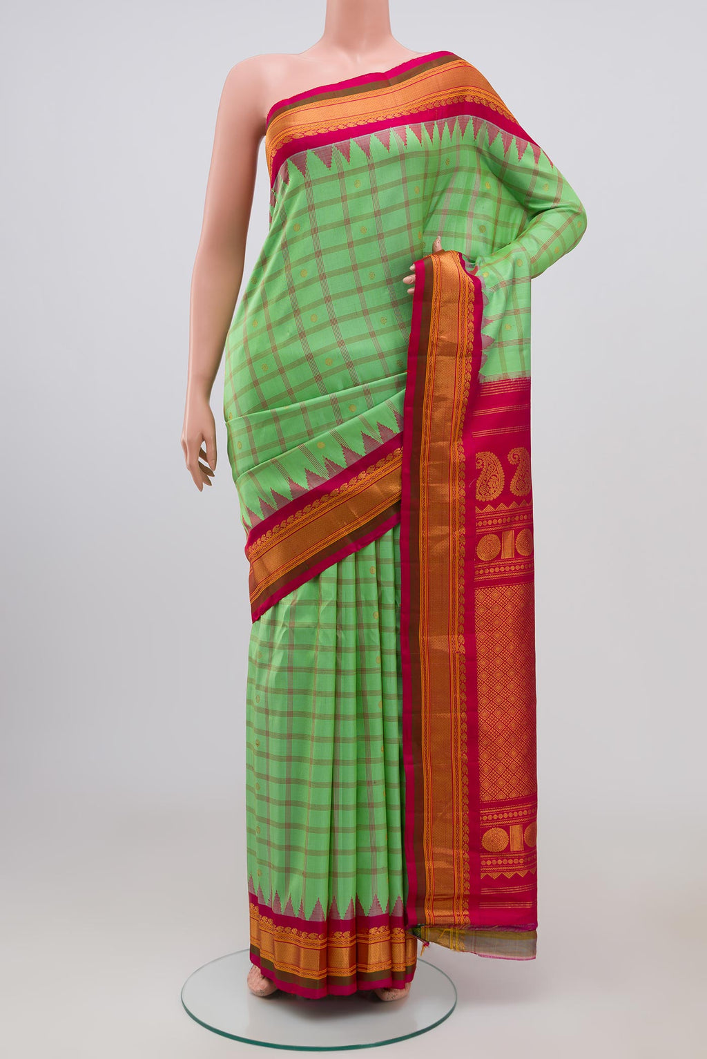 Green Gadwal Silk Saree with Zari Butta on the body and Zari Border.  displayed on a mannequin