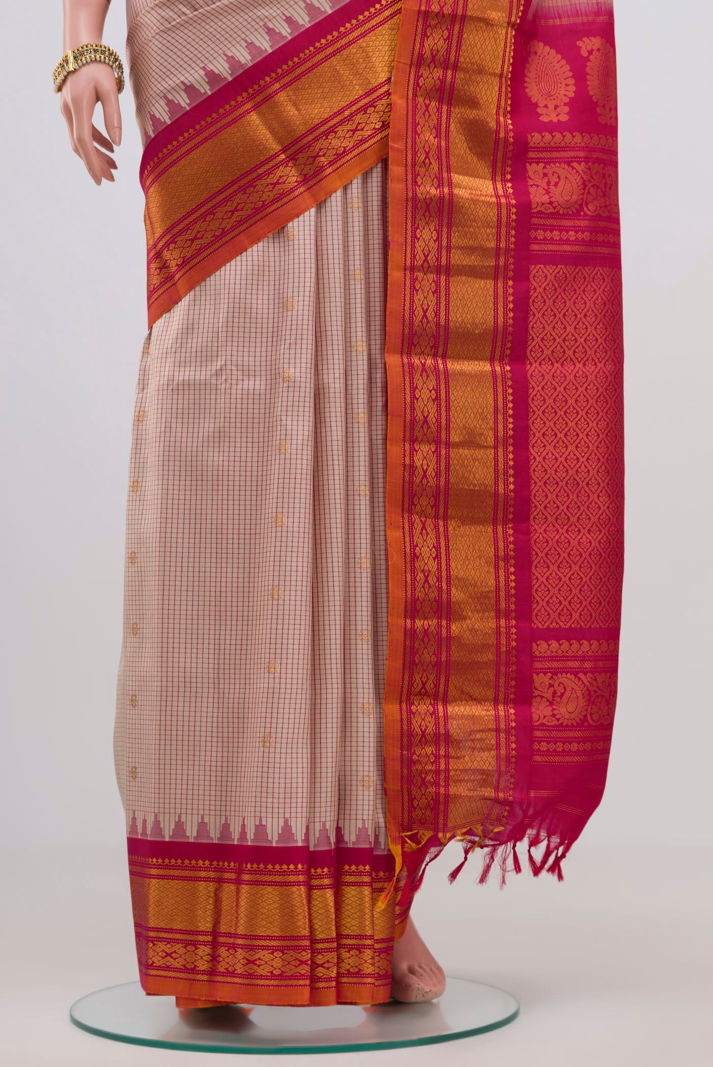 Pleats and pallu of Cream Gadwal Silk Saree with Checked design on the body and Zari Border. 