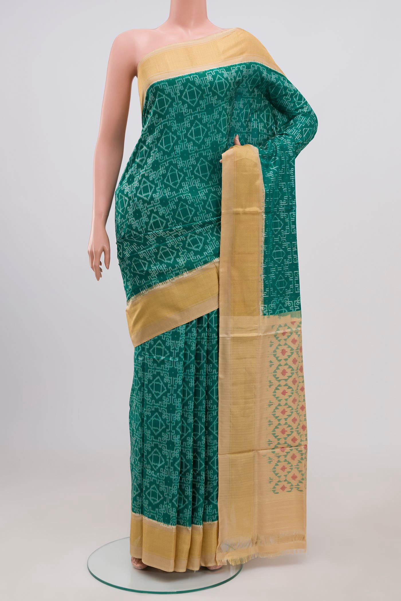 Green Pochampally Silk Saree with Ikat Print on the body and Zari Border.  displayed on a mannequin