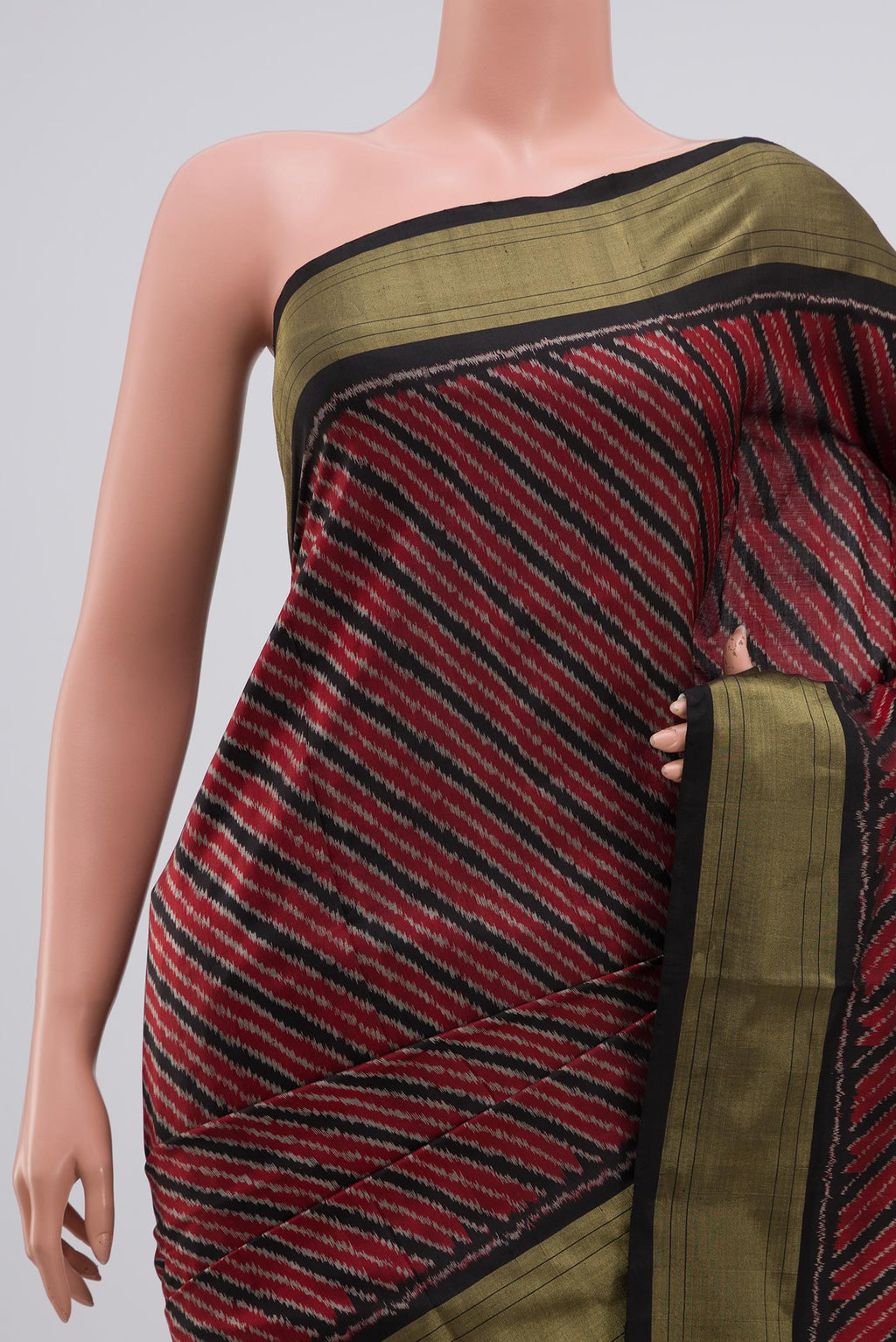 Border image of Maroon Pochampally Silk Saree with Ikat design on the body and Zari Border. 