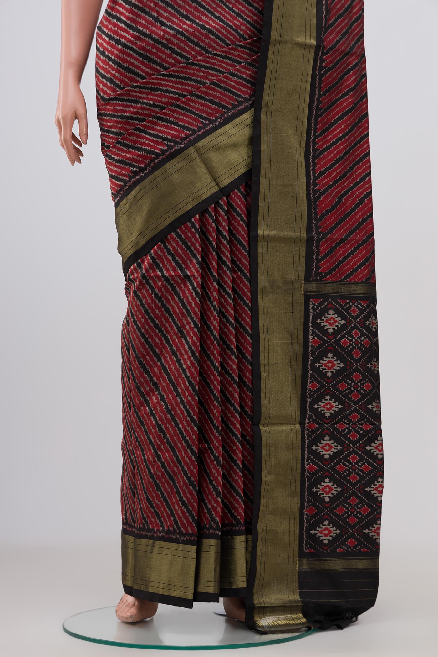 Pleats and pallu of Maroon Pochampally Silk Saree with Ikat design on the body and Zari Border. 
