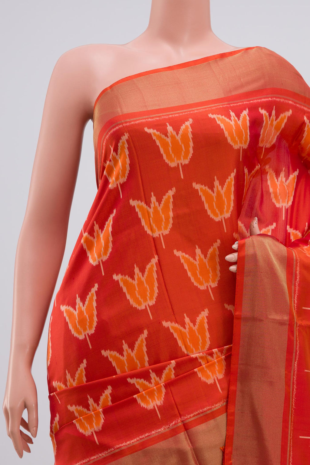 Border image of Orange Pochampally Silk Saree with Ikat design on the body and Zari Border. 