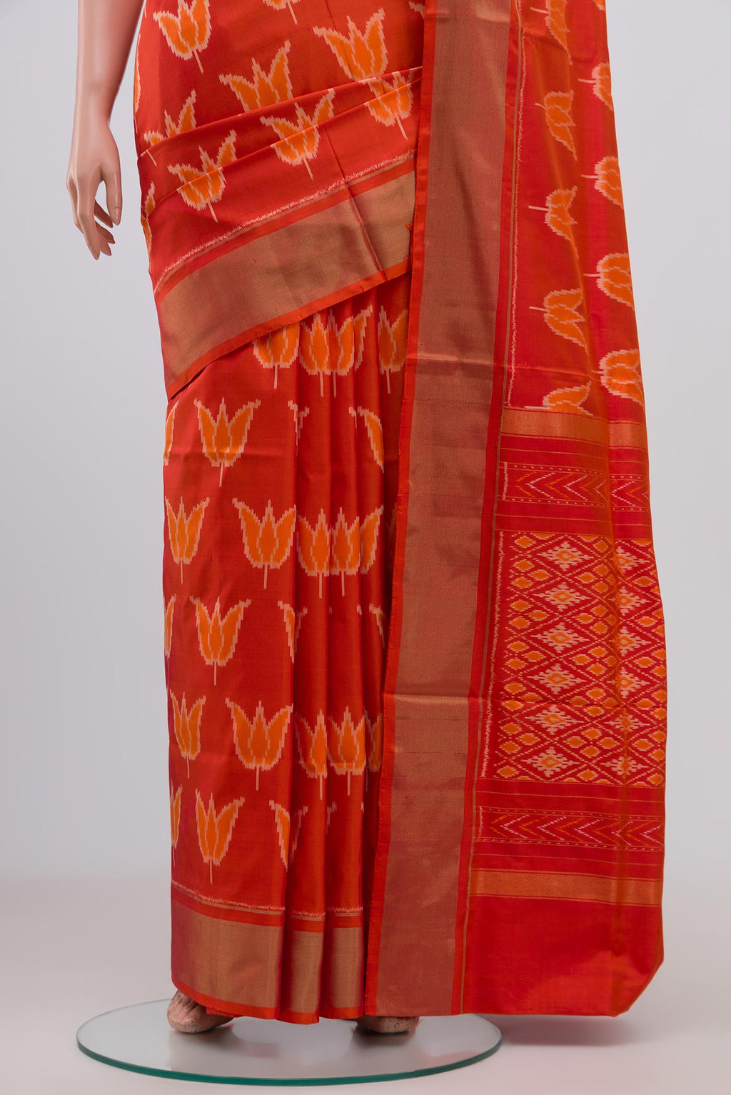 Pleats and pallu of Orange Pochampally Silk Saree with Ikat design on the body and Zari Border. 
